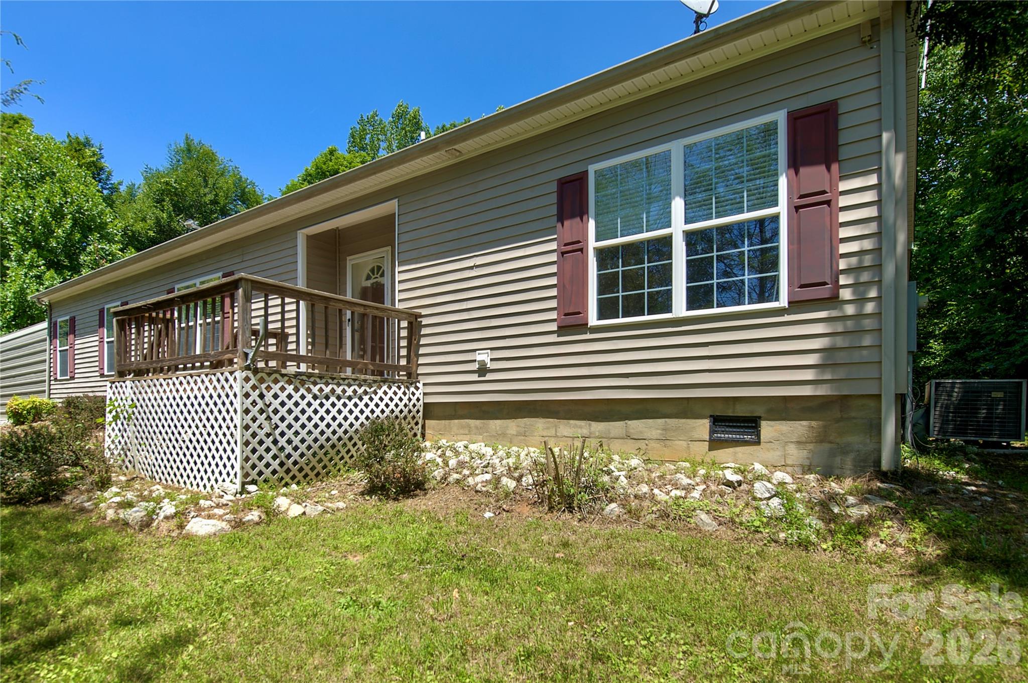 Tucked away in the heart of the High Blue Ridge Mountains, this well maintained 2005 modular home offers a peaceful, elevated living at over 3,000 feet. Surrounded by the majestic Unaka Mountain range and towering Roan Mountain, one-level living that delivers comfort and  privacy,

The open-concept layout is perfect for easy living and entertaining. The spacious kitchen features a large island and breakfast bar, while the inviting living area showcases a cozy gas-log fireplace. The split floor plan includes a generous master suite with ensuite bath (soaking tub + walk-in shower) and two guest bedrooms with oversized walk-in closets. Natural light floods the home throughout.

The private 12x42 covered back porch complete with a hot tub —offers the perfect spot to unwind under the stars. Additional features include a 26x26 carport, paved driveway, 12x32 storage building, and an 11x20 dog kennel. Located in the High Country of Western North Carolina, offering the best of both worlds: serene country living with convenient access. You’re just minutes from Bakersville and Burnsville, 40 minutes to Johnson City, TN, and only 50 minutes to Asheville. Enjoy hiking the Appalachian Trail, exploring the Toe River, and all the outdoor adventures the region has to offer.  Whether you’re seeking a peaceful full-time mountain home or a high-potential rental investment, this property delivers. Ready to escape to your own slice of the Blue Ridge? Call today to schedule a private showing before it’s gone! No HOA, No Fees!