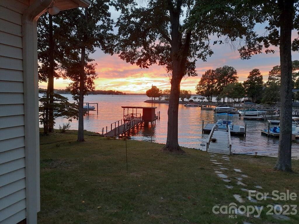 Back on the Market! No fault of the seller. Excellent location! EXIT 28
This property is a gem of a starter home in beautiful condition.Sellers have been devoted to this home and its upkeep. Move in ready or renovate in time. Bahia Bay, original Lake Norman Community.Quaint,MINIMAL HOA  with a rustic charm. Several builders such as Simonini have recently built homes there.
SUNSETS FOR DAYS! Unbelievable partial BRICK RANCH property on large lot.Slate entryway to this sweet lake cottage with an open vaulted ceiling. Newly renovated neutral kitchen and dining room with expansive island for entertaining.Side entrance from kitchen to your cutting garden. Sunroom with views from all windows for watching boaters. Porch on the rear of the home with automated awning. Waterfront primary bedroom with ensuite bathroom.Home is being sold "as is where is" Buyers are welcome to do inspections. There will be no negotiations on repairs. Washer, Dryer and Refrigerator remain.
