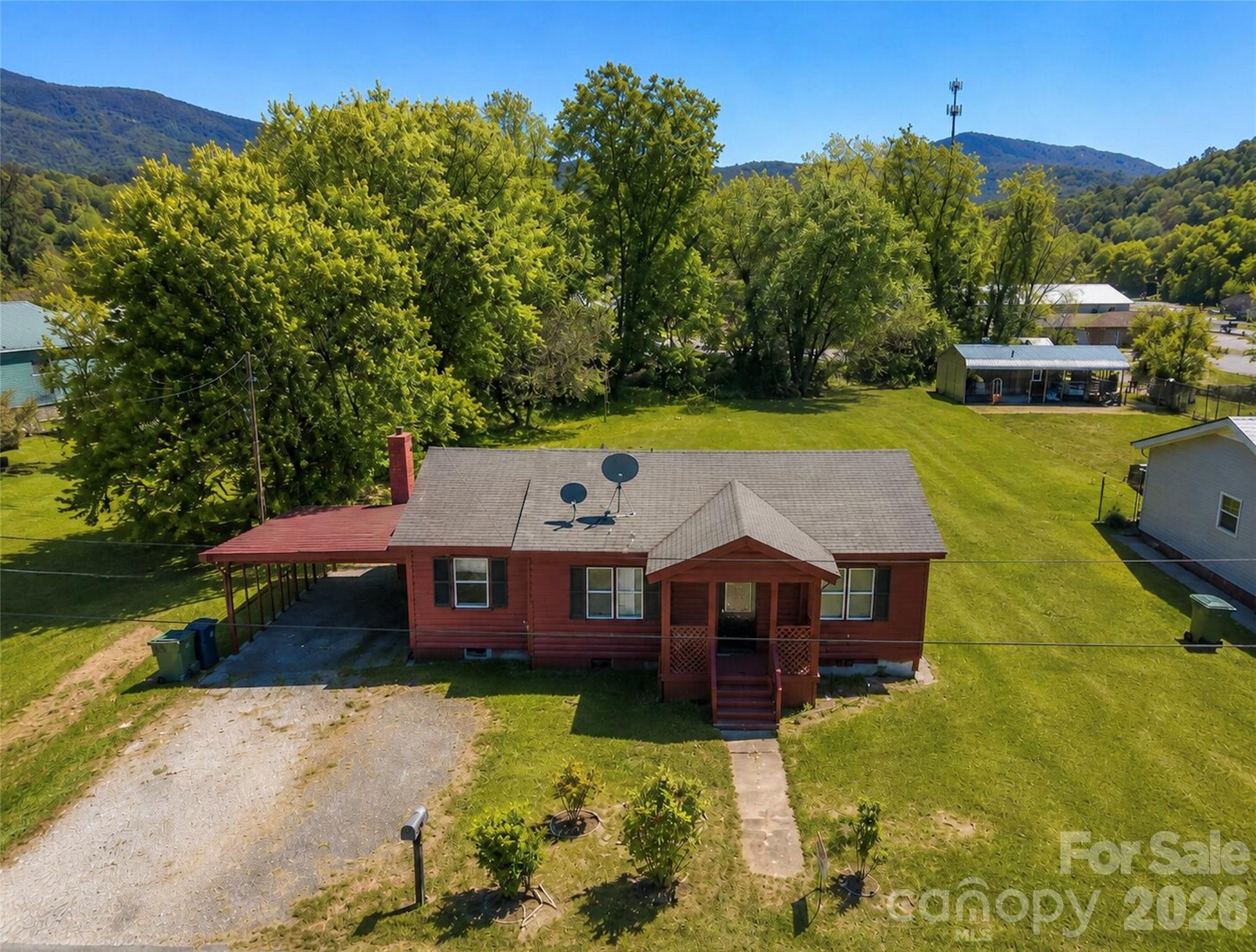 Owner financing offered with acceptable terms. Investment opportunity inside Waynesville city limits on a level 0.37-acre lot with city water and sewer. Conveniently located near downtown Waynesville, Waynesville Country Club, Waynesville Commons, and Main Street, this 1957 home offers 1,116 square feet, a front porch, covered carport, and a deep lot that extends toward Cochran Street. Property is recognized as 51 Robinson St for mailing and access, with tax records tied to 49 Robinson St. Hazelwood zoning and lot depth may support additional use potential in the rear, subject to zoning and town approval. Solid value-add opportunity for investors, or builders