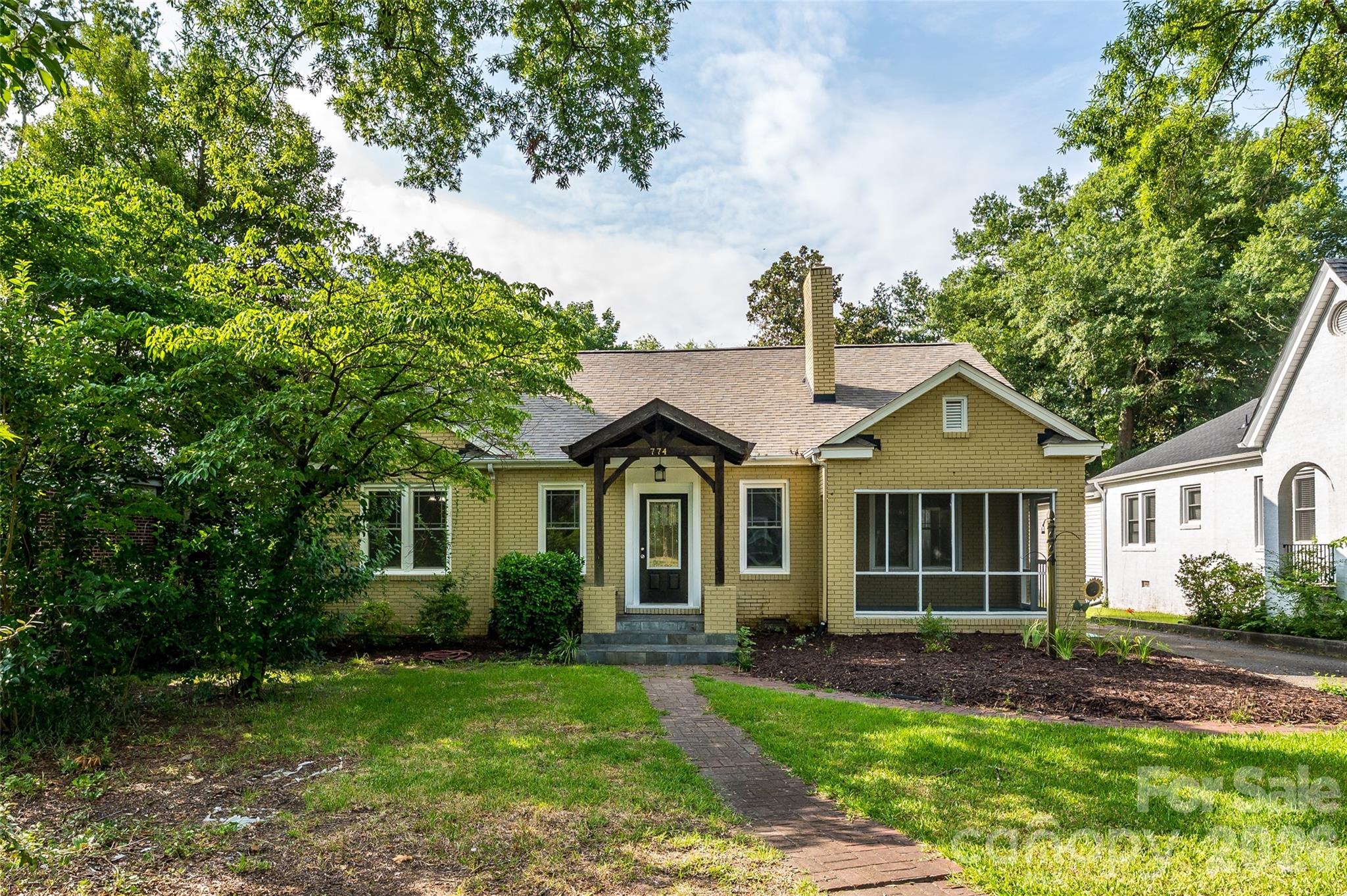Charming brick home nestled on a picturesque, tree-lined street just half a mile from Winthrop University. This inviting residence blends timeless character with thoughtful modern updates throughout. Inside, you’ll find original hardwood floors and rich crown molding anchoring the living and dining spaces, complemented by fresh interior paint and updated LVP flooring in the kitchen and breakfast area. The kitchen offers both style and function with resurfaced Corian countertops, a classic subway tile backsplash, breakfast bar, gas cooktop, and stainless steel appliances. A separate dining room and sunny breakfast nook provide flexible options for everyday living and entertaining. The main level features three comfortable bedrooms, an updated full bath with new vanity, lighting, and subway-tiled shower, along with a convenient Jack-and-Jill half bath. Upstairs, two additional bedrooms, a full bath, and a versatile loft space create the perfect setup for guests, work-from-home, or additional living space. Enjoy quiet mornings or relaxed evenings on the cozy screened-in side porch. An unfinished basement provides abundant storage. Refrigerator and washer/dryer included. Major updates include a new roof (2023) and HVAC (2019), plus fully paid-off solar panels for enhanced energy efficiency and lower utility costs. Whether you're looking for a primary residence or a smart investment opportunity near campus, this home offers exceptional versatility in a highly desirable location.