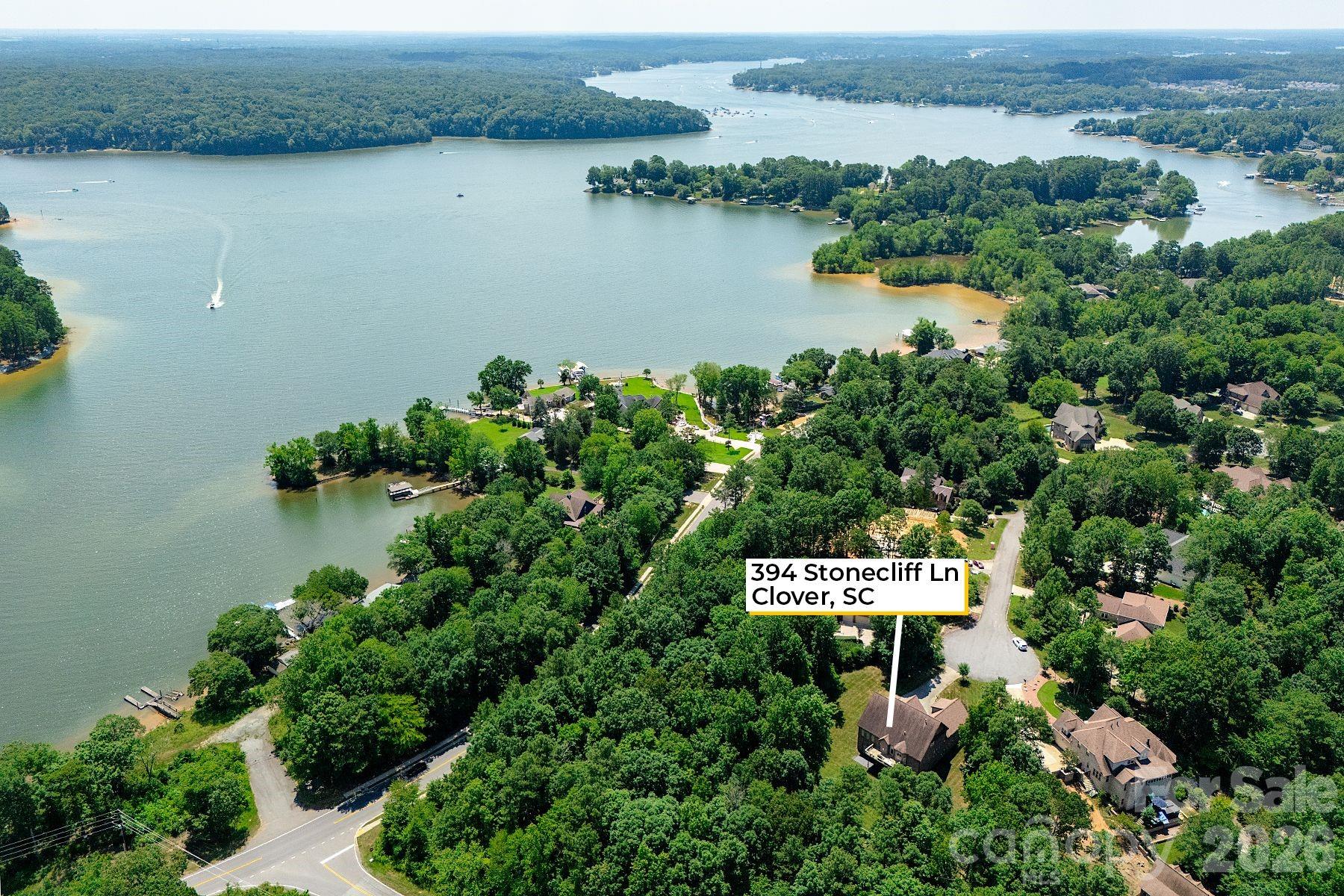 Zoned for NEW LAKE WYLIE HIGH SCHOOL! The FULLY FINISHED WALK OUT BASEMENT is a standout feature, perfect for a private guest suite, multigenerational living, or a comfortable mother-in-law retreat. Stunning designer home located in a quiet cul-de-sac! It includes a private office with elegant French doors, a stylish wet bar with granite countertops, a spacious recreation room with an electric fireplace, a dedicated exercise room, a large bedroom, a full bath, and additional laundry hookups. Gourmet kitchen that is truly the heart of the home. It boasts gleaming quartz countertops, tile backsplash, newer appliances, and a walk-in pantry that offers ample storage. Adjacent to the kitchen is a cozy keeping room with custom built-in cabinetry. The sunny breakfast nook features a charming built-in bench seat and offers a beautiful seasonal lake view, making every morning feel like a retreat. The main-level primary suite showcases double tray ceiling, a spa-inspired en-suite bathroom with quartz countertops, garden tub, separate shower, and custom closet shelving. Spacious secondary bedrooms, including one with its own private en-suite bath—perfect for guests. A massive bonus room provides versatile space that could easily be converted into a home theater, media room, or play area. This home grants access to award-winning Clover schools.  A Marina, Boat Storage and Restaurant just a few miles away.