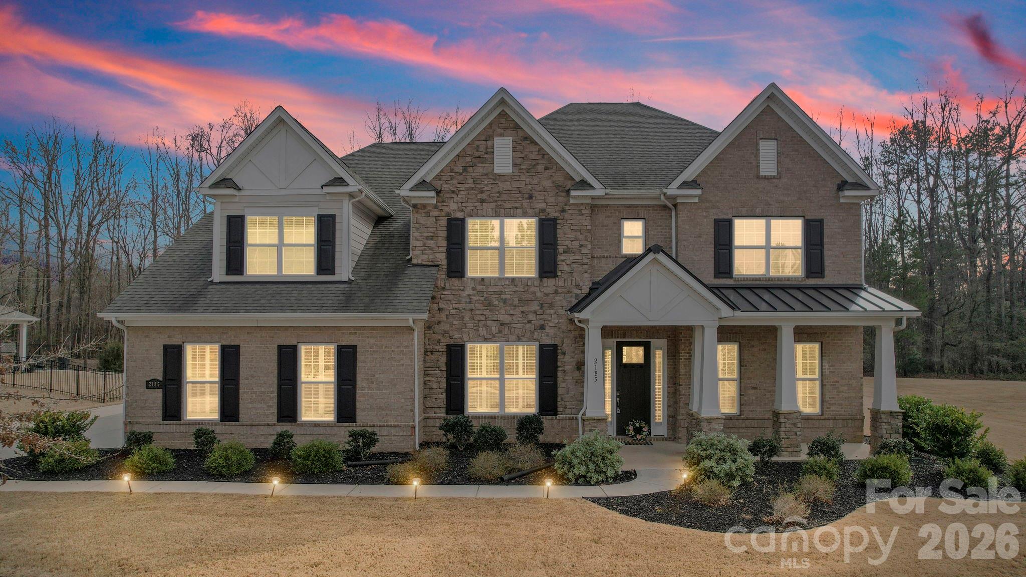 Experience elevated luxury at 2185 Loire Valley Dr, an elegant estate home in the exclusive gated community of Bretagne, just minutes from Ballantyne. Built in 2020 and completely turnkey, this stunning residence offers five en-suite bedrooms and modern luxe finishes throughout. Inside, an open layout reveals a private study and a great room flowing into a gourmet kitchen with quartz counters, double ovens, and a butler’s pantry. Main level includes a guest suite (second primary); upstairs, a large bonus room expands the living area, and the primary suite offers a spa-like bath and a private balcony overlooking wooded grounds.
Set on a flat 0.70-acre lot, the home provides ample privacy, perfect for a future pool or garden oasis. Enjoy resort-style community amenities including pool, cabana, and clubhouse plus top-rated schools, shopping and dining nearby. A rare opportunity to own an elegant, move-in ready home that blends luxury, privacy, and convenience in one of Charlotte’s most sought-after enclaves.