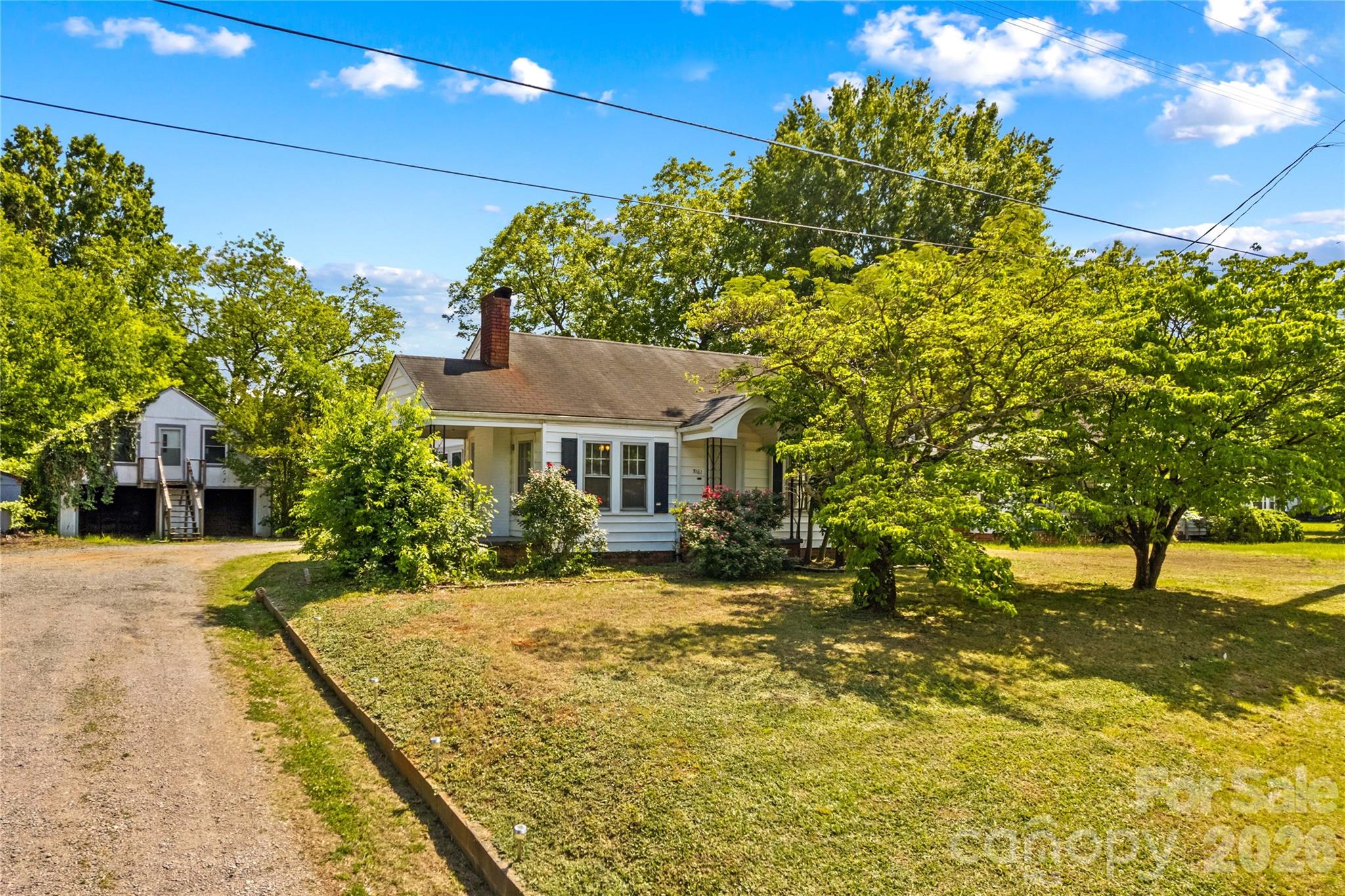This 2 bed/1 bath bungalow with large outbuilding in fantastic location. Convenient to shopping, I-85, 73 & 29.  Lovely starter home or investment opportunity.  This home features a freshly painted interior and newer laminate floors throughout.  HVAC was replaced and updated to include central air in late 2023.  This home comes with a large outbuilding offers over 600sf of storage in total.