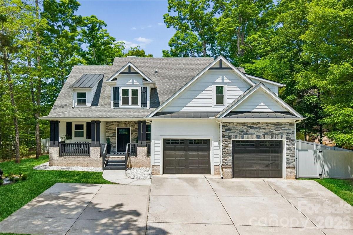 Welcome to 9712 Worley Drive, a beautifully updated 2023 build tucked into an incredibly private wooded setting in Charlotte. This immaculately kept home features a desirable first floor primary suite with custom wood finishes, a sleek double vanity, and a walk in closet. The custom designer finishes throughout every room seal the deal, with luxury tile elevating the open concept living and dining space, fireplace, kitchen, stairs, dry bar, and all 3 bathrooms, giving the home a polished, high end feel from the moment you walk in. Upstairs, the loft provides incredible flexibility as a bonus room, office, fourth bedroom, or second living space. Outside, the backyard feels like a private retreat, complete with a covered back porch, wooded views, and a new spacious and reinforced concrete patio with ample room for entertaining. Additional upgrades include cleared trees, added grass, greenery, and a privacy fence. The backyard extends to the cul de sac behind the home and the front yard includes the two parking spaces at the end of the driveway. The community also offers two large private natural ponds maintained by the HOA, stocked for residents to enjoy fishing and paddle boating. With thoughtful updates throughout, excellent privacy, close proximity to Publix, Harris Teeter, Charles T. Myers Golf Course, Target, Lowes, and nearby recreation at The Club at Waverly with activities like hiking, canoeing, and tennis, this home offers the perfect blend of modern design, comfort, convenience, and peaceful outdoor living.