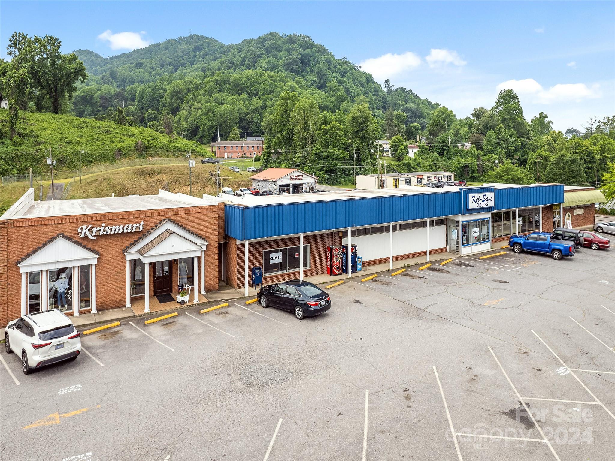 One of the Highest visible sites in Sylva , North Carolina Solid Masonry building on 1.46 level acres with City utilities and Signage. The Plaza is located at the Intersection of East Main Street ( Highway 107) and Business 23 . There is a very high traffic count that travels past this intersection 24 hours a Day. The previous KelSav Pharmacy was a Landmark in Sylva for years along with a Dress Shop and Health Foods Store all for sale or Lease. The 10,000 square foot Kelsav building is for Lease at $10/ft NNN and the 10,000 square foot Basement area is for lease at $5/foot NNN. All buildings have great delivery entrances on the rear.