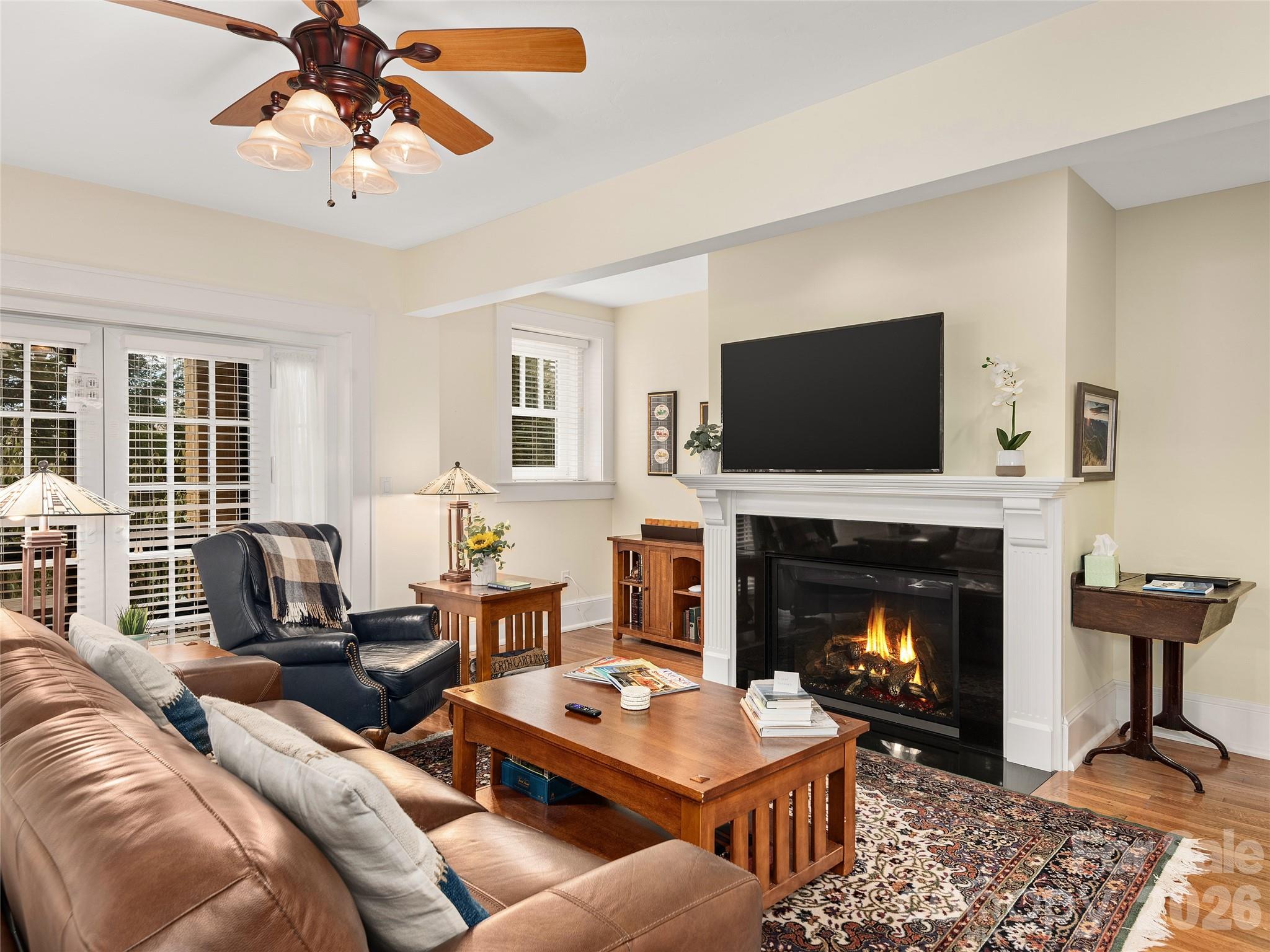 Timeless in design and thoughtfully reimagined for modern living, the Landmark offers a rare opportunity to own a distinctive piece of Hendersonville’s history—where preserved architectural charm meets refined comfort and exceptional potential as both a personal retreat and income-producing investment! 

In the very heart of Hendersonville — yet quietly tucked just one block from downtown — this exceptional residence offers a rare balance of sophistication, privacy, and opportunity. Whether envisioned as a refined personal retreat or a proven income-producing property, this ground-level unit at 203 6th Ave W, Unit 1B represents a truly distinctive offering at this price point.

Set within a beautifully restored historic building, the residence has been thoughtfully renovated to honor its architectural character while incorporating modern comfort and efficiency. The renovation included cotton batt sound insulation and additional energy-saving, sustainable features, creating an interior that feels serene, efficient, and exceptionally well-constructed — a level of quality that cannot be replicated in this location today with the reuse of the original materials such as the oak flooring! 

For those seeking flexibility, the property already holds an established short-term rental history with consistent performance and seamless transferability of systems in place. It is equally suited, however, for owners who desire a sophisticated downtown residence without sacrificing peace and quiet.

Inside, the open-concept layout feels bright and welcoming, complemented by tasteful finishes and subtle design details that reflect both heritage and contemporary style. Two private outdoor sitting areas extend the living space and enhance the ease of ground-level access — ideal for everyday living or hosting guests.

Step outside and you are moments from Hendersonville’s celebrated Main Street, where boutique shopping, cafés, galleries, dining, and year-round festivals create a vibrant cultural backdrop. Yet, once inside, the sound-insulated design delivers a calm, retreat-like atmosphere — even on the liveliest evenings downtown. Owners also enjoy exclusive rooftop access, offering elevated views and a perspective of Hendersonville that few experience.

Beyond the city center, the lifestyle continues: DuPont State Forest and Pisgah National Forest are within easy reach, Asheville Regional Airport is approximately 30 minutes away, and Charlotte Douglas International Airport provides convenient access for both business and leisure travel.

Downtown opportunities of this caliber — particularly at the ground level — are increasingly rare. As Hendersonville continues to grow, this residence stands as a unique piece of the city’s fabric: historically rooted, sustainably upgraded, and positioned for both enjoyment and long-term value!

This is your chance to secure a property that offers not only location, but distinction.
Schedule your private showing and experience what makes this opportunity truly exceptional.