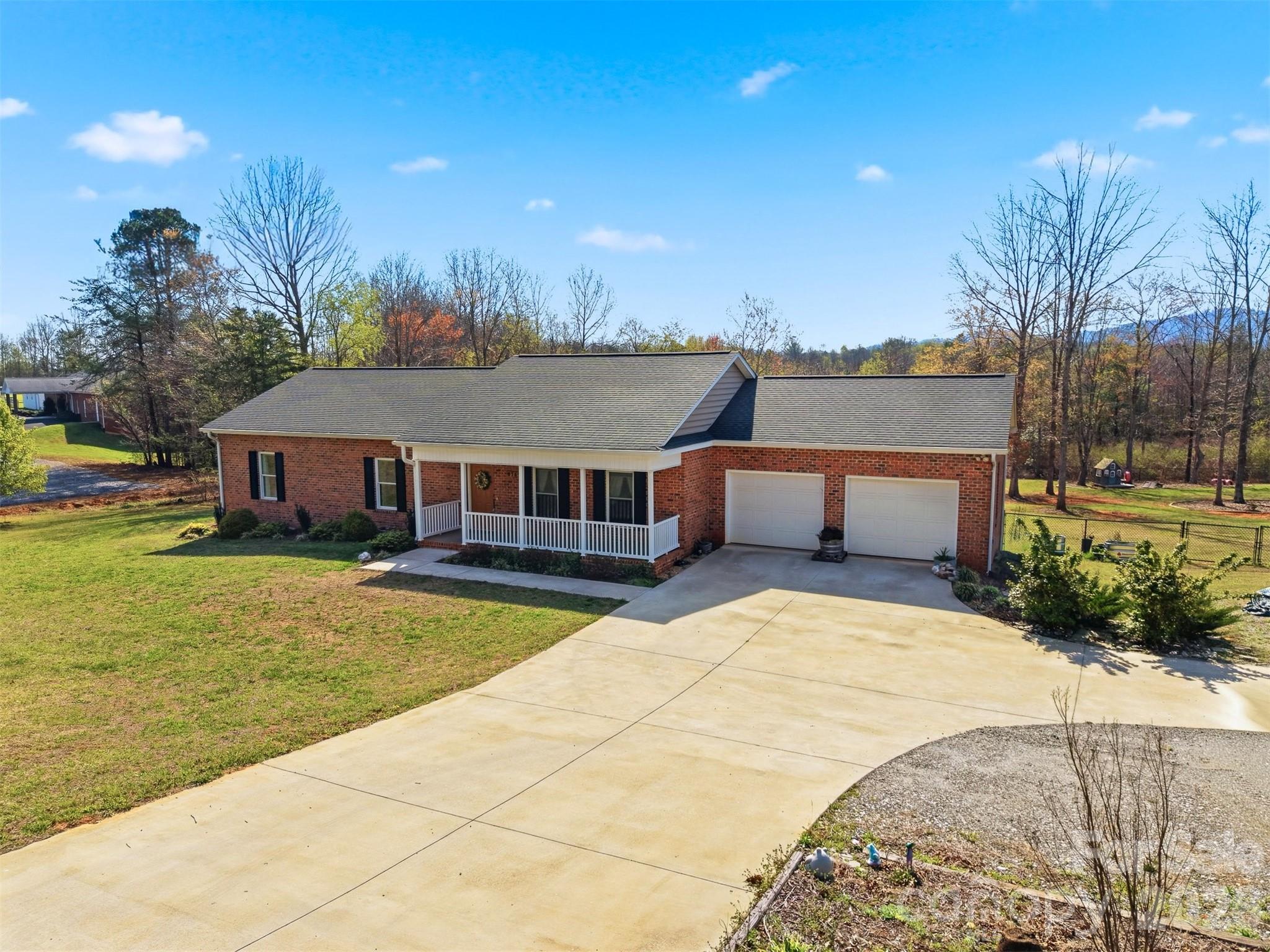 This delightful 3BR, 2 bath brick ranch style home is the perfect place to call your own! Enter from the covered front porch into the open concept floor plan. There is luxury vinyl plank flooring & a neutral color palette. The kitchen has abundant cabinets, large island with eat-at bar and granite counter tops. Move through French doors to the enclosed heated/cooled sunroom. Then walk out onto the expansive back deck and jump into the above ground pool or relax overlooking the fenced back yard. The primary bedroom has an en suite bath & the secondary bedrooms have a large bathroom in the hallway. The two car garage is oversized with plenty of room for storage. In addition there is a gravel circular drive for extra parking. Call for your showing today!