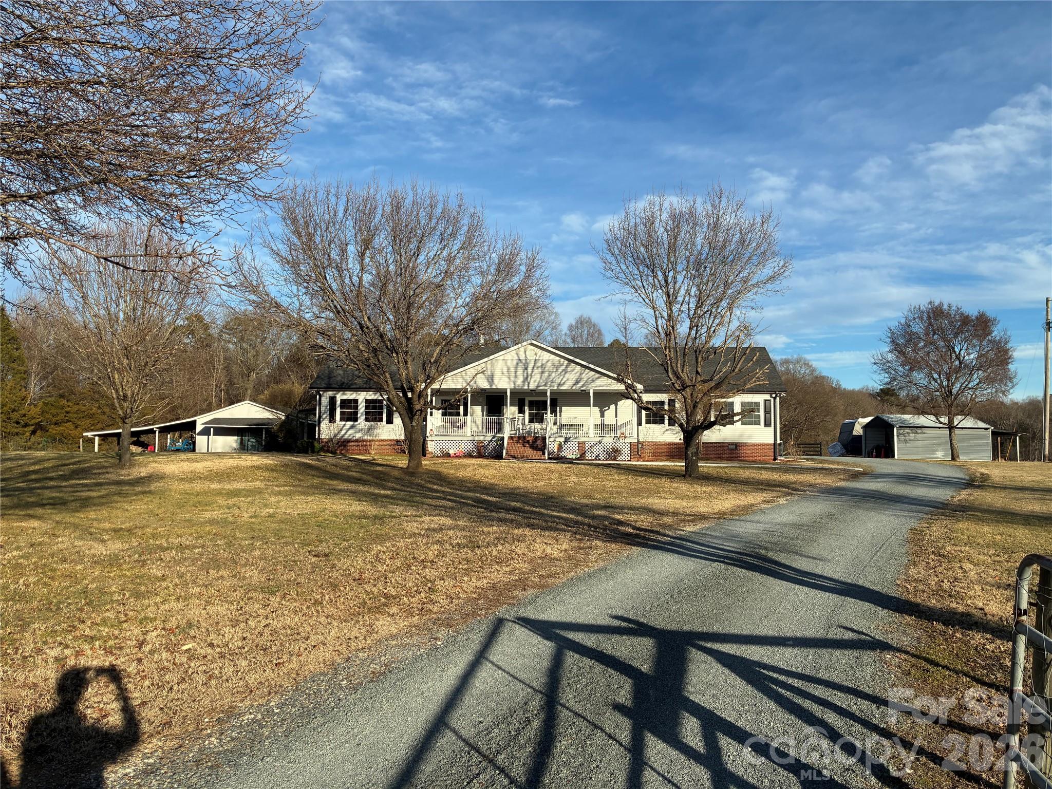 Beautiful country setting. Enjoy sitting on your back porch and watching the sunrise and sitting on the front porch and watching the sunset. End to end covered porches overlooking your beautiful farm plenty of storage in the 1200 sq ft four bay garage with a 400 ft.² attached apartment with full bath. Multiple buildings for storage.Raised bed gardens.Minutes from Locust and Midland.