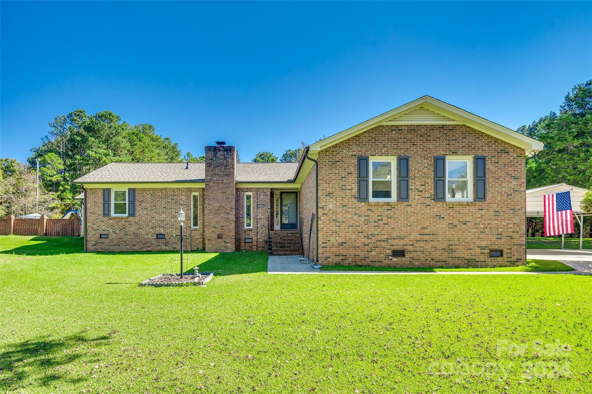 Welcome to this serene all-brick split-level home on 2.62 private acres in Catawba, SC. This 3-bedroom, 2.5-bath property blends classic charm with modern amenities. The landscape, 3-bay carport, and oversized double-bay shop offer ample storage and workspace. Natural light fills the cozy sunroom, while the spacious rec room with new carpet and separate entrance provides flexible living space. The living room features a wet bar and wood-burning stove, while the private backyard with a covered porch, pool, and outdoor changing room is perfect for entertaining. The kitchen boasts granite countertops, a center island, and built-in fridge, with appliances, including a new washer and dryer, conveying. Established neighborhood with no HOA, it's convenient to outdoor activities and downtown Rock Hill. Schedule your showing today to experience this peaceful retreat!