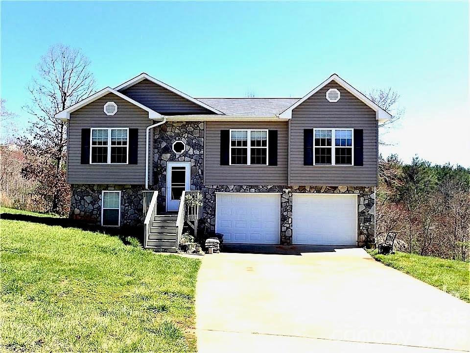 Turn-key and beautifully updated home just minutes from Lake James! This 3BR/3BA property features a partially finished basement with a den or potential 4th bedroom, offering flexible living space. Recent updates include fresh interior paint, LVP flooring and carpet (2023), HVAC (2024), new 30-year roof (2025), wood blinds, gas range, and septic pumped (2024). The main level boasts an open-concept layout with vaulted ceilings, seamlessly connecting the living, dining, and kitchen areas. All three bedrooms are conveniently located on the main level, along with two full baths. The primary suite offers a private full bath and walk-in closet. Additional highlights include an oversized garage, abundant storage throughout, and a partially finished basement for added versatility. Located in a small, established neighborhood with no city taxes, this home combines comfort, updates, and convenience in a desirable setting near Lake James.