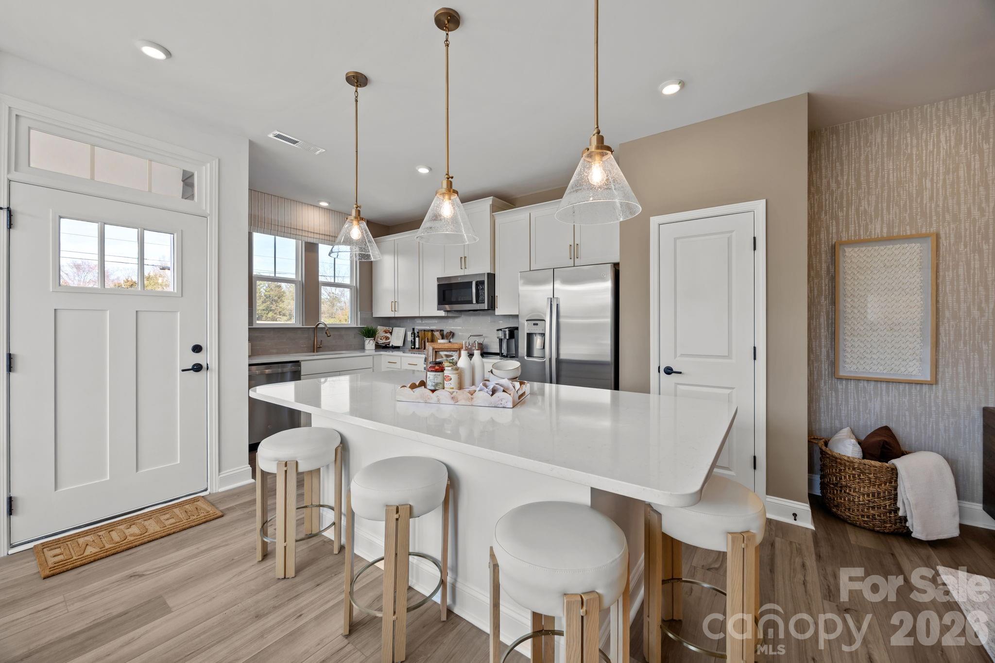 Welcome to Odell Park Premier Townhomes Offering the Most Convenient Access to Regional Commuter Routes and Concord Mills. Our Rochester plan features 3BR / 2.5BA  with a 1-car garage offering modern design and practical spaces just minutes to I-485 , Highland Creek, and Concord Mills Blvd. The main level features an open-concept layout with luxury vinyl plank flooring. The kitchen includes quartz countertops, stainless steel appliances, a spacious island, and an approximately 12' deep finished storage closet—ideal for pantry or utility use. A bright dining area and connected family room make the space inviting for both daily living and entertaining. Upstairs, the Rochester plan offers three bedrooms, two full baths, and a convenient laundry closet. The primary bedroom and bathroom highlight a 5' tiled shower, dual vanities, and a large walk-in closet. Secondary bedrooms provide flexibility for work-from-home, guests, or hobbies. Odell Park offers quick access to  shopping, dining, parks, major highways, UNC Charlotte, and local employment centers. HOA services cover water, trash removal, lawn care, and landscaping, supporting a low-maintenance lifestyle in a convenient Charlotte location. This home will be ready for a quick move in.