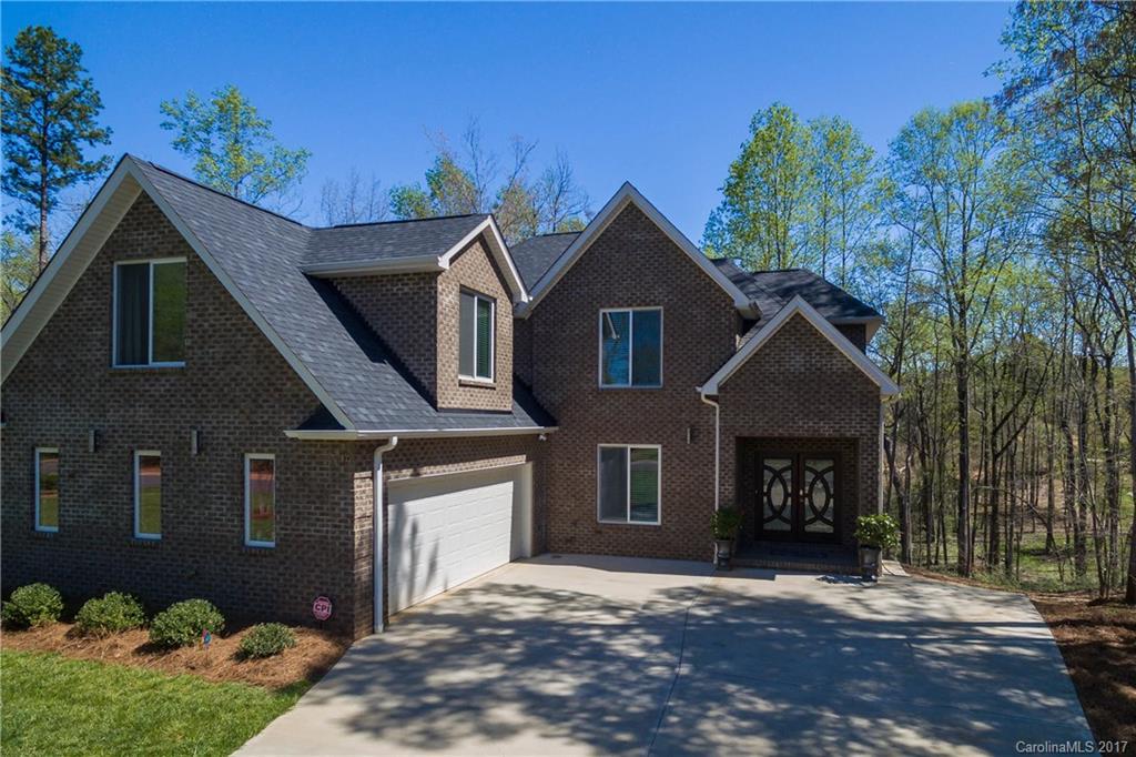 Come check out this fun and modern home located in the beautiful River Walk Plantation of Charlotte. Private setting, Catawba River views, covered balcony with patio below, treehouse, and an extra golf cart garage in back is just the beginning. The inside walks beautifully as well with the open concept and all modern finishes throughout. Heated floors in kitchen, garden tub and walk-in shower in master. Mudroom, tray ceiling in master, two-story great room, double-door entry, oversized garage.