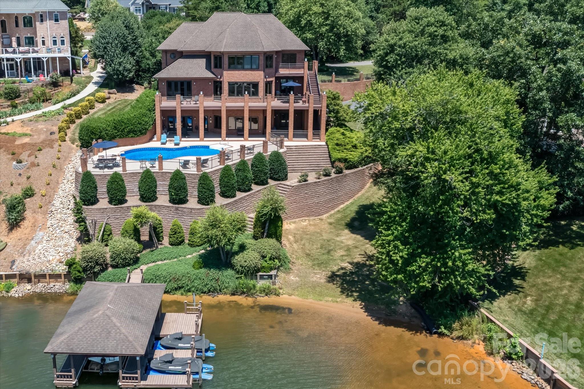Incredible lakefront estate in the coveted Olivers Landing golf community. Custom built home designed to enjoy and relax in a luxurious environment offering spacious gathering areas and lovely retreats throughout the spacious 7400 square foot immaculately maintained home on three levels with year round views of Lake Hickory from each level. The main level has an exquisite private owners suite, complete with a spa-like bathroom with soaking tub, separate shower, double vanities and generous size walk-in closet/dressing room. The home chef will love the kitchen complete with custom made cabinetry, oversized gas range, commercial sized refrigerator, two sinks, and large center island. Gather and entertain in the eat-in kitchen, formal dining room, expansive upper deck and pool deck/patio area. This prestigious home is nestled on a cove lot where you have year round views of Lake Hickory and in the evenings can capture the beauty of the sun setting over the water. The upper level of the home is the perfect place for hosting friends and extended family, with three en-suite bedrooms, separate living area, billiards room, and home theater with projection screen. The lower level features a great flex space with wet bar, sunny den/family room with easy pool access. Did I mention the lake views? Also on the lower level is an exercise room/home gym area and additional extra spacious bedroom and full bath  Another perfect place for overnight guests. Lake Hickory is a spectacular 4200 acre lake with over 100 miles of shoreline. The lake can be seen from most rooms of the home. The in-ground pool overlooks the lake and offers easy access to the boathouse (with covered storage as well as other docking areas for additional small crafts and jetskis).  Amazing times and wonderful memories to be made for both you and your guests!  A wonderful opportunity to make this one-of-a-kind yours. Olivers Landing is Hickory's premier golf and lake community, offering an 18-hole, par-72 course, pro shop, driving range, club house, restaurant, and shared boat slips. It is conveniently located 20 minutes to Downtown Hickory and less than 1.5 hours to Charlotte or Asheville.