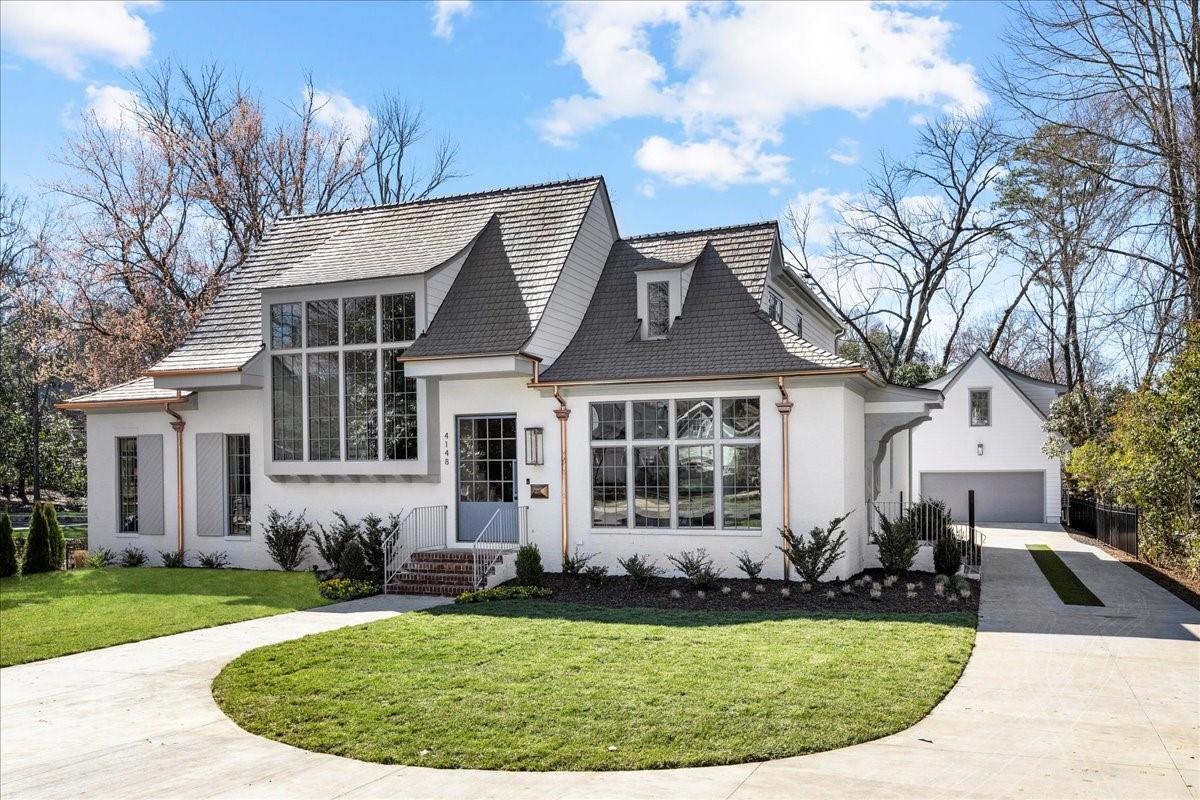 Masterfully designed and filled with architectural beauty! Grande Custom Builder's has created a unique masterpiece with the utmost attention to detail. From the moment you enter through the impressive steel pivot front door, you find an inviting and open floor plan conducive to everyday living.  Back slider opens wall to wall to a covered porch with fireplace, automated screen, Infratek heaters, and pool w/hot tub, combining the indoors and out. Home features a stunning chefs kitchen with scullery making entertaining a dream. Main floor primary with incredible natural light, dreamy bath with heated floors and W/D hookup in large walk-in closet. 3 secondary bedrooms, 3 full baths, laundry room, and bonus up. Detached garage is heated/cooled on BOTH floors. Use as garage with EV charging station or use as a chic and functional pool house with half bath and outdoor shower.  2nd floor offers 5th bedroom, full bath and kitchenette.  Truly luxury living in Olde Cotswold!