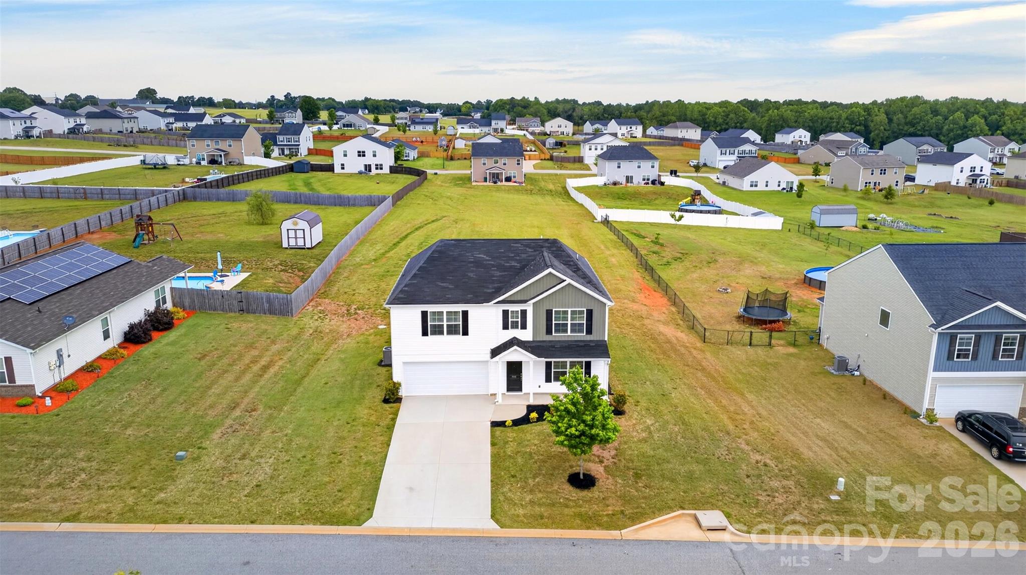 Practically brand new and shows like it — Mungo "Russell" plan on a 0.58-acre lot in Adens Place. Out back, the expansive yard meets unfenced open green space on the lot behind, for a parklike, wide-open feel rarely found in newer Boiling Springs construction. Step inside to a flexible downstairs office (work-from-home, study, hobby room — your call), then the floor plan opens up. Granite kitchen with walk-in pantry, upgraded cabinets, oversized island, and pendant lighting flows into the great room. The garden door opens to the backyard. Half bath downstairs handles guests. Upstairs, the primary suite stretches out: tray ceiling, DUAL walk-in closets, double-sink raised vanity, garden tub, and separate tile shower. Three more bedrooms — each with a walk-in closet — share a second full bath. Laundry is upstairs, where it should be. The flex play: a generous LOFT. Media room, second living space, gym, hobby zone — whatever fits your lifestyle. Energy built in: R-30 insulation, advanced framing, programmable thermostat, low-VOC finishes. Tilt-out windows. 2-car garage. Attic storage. Carlisle-Foster's Grove / Rainbow Lake / Boiling Springs schools. HOA $210/year. Flood Zone X. Public water, septic, electric heat & cool. Schedule your showing today.