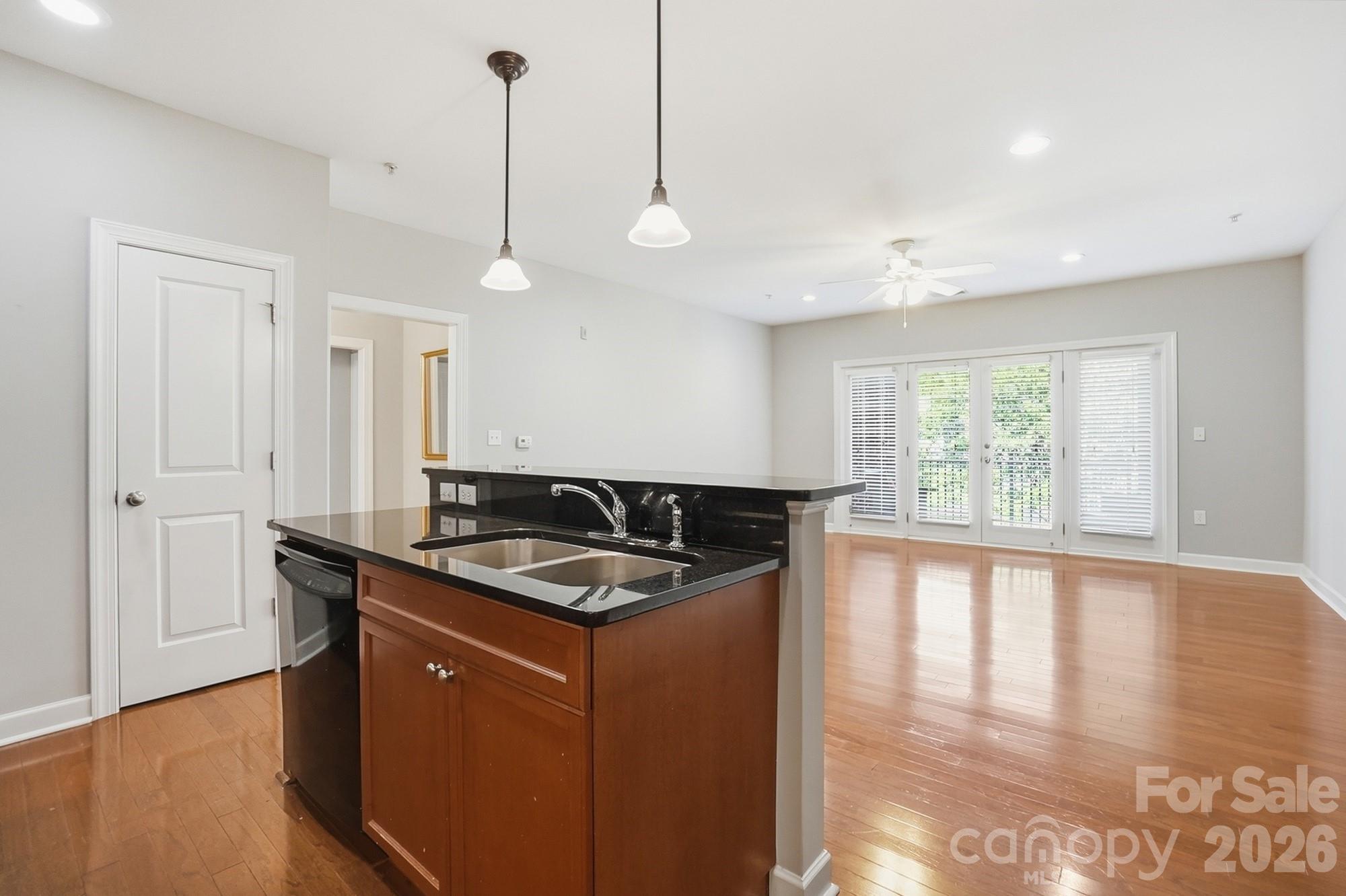 NEW PRICE in one of Dilworth's largest one-bedroom floor plans. A wonderful opportunity to live in Dilworth Walk, a perfect blend of historic charm and modern urban living.  Beautifully maintained 1 bedroom, 1 bathroom condo that offers an open concept layout that opens to a spacious covered balcony. This is one of the largest 1-bedroom condos in Dilworth at this price!  The large windows and high ceilings create an airy and expansive feel throughout the main living area.  The kitchen features modern cabinets, granite countertops,  new glass backsplash and under-cabinet lighting, providing a great environment for cooking and entertaining.  The spacious primary bedroom has two closets and easy access to the well-appointed bathroom.  French doors lead to a private and sunny covered balcony. NEW water heater replaced in April 2026, NEW carpet in primary bedroom and newer washer/dryer. This location allows for easy access to local favorites like Latta Park and Freedom Park. Fresh Market and Harris Teeter are just around the corner!  You will also love the close proximity to Dilworth's finest dining, boutique shopping, and coffee houses. Secure building with assigned 1-car spot in gated garage.  Visitor parking is available in the back and front of the building.