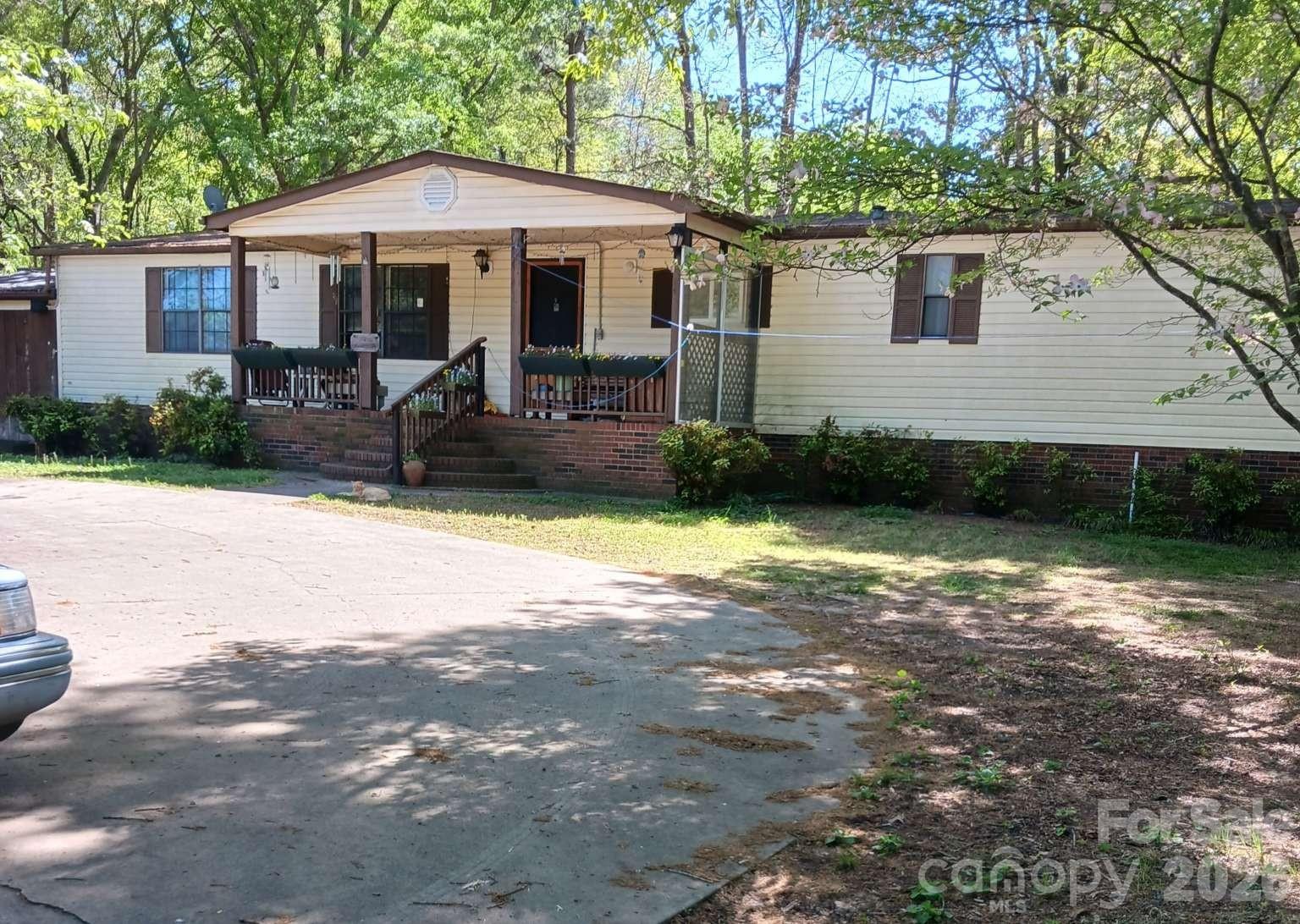 HOME WARRANTY INCLUDED - COUNTRY RANCH ON .98 ACRES Private 3 bed, 2 bath one-level home on a quiet dead-end street for easy living for you and your animals! ACCESSABILITY: True flat single-story layout, zero-step handicap entry from the enclosed garage/workshop, wide 32" doors and a spacious walk in shower with handi-cap rails. PREMIUM FEATURES: Living rm features custom, real wood v-joint walls. Fully fenced back yard. Stunning private pond with colored night-lighting and fountain. Equipped with newer, high energy, efficient heating and cooling mini splits. New kitchen and primary bath countertops and floors. Front and back covered porches. PEACE OF MIND: Move in with total confidence. Seller pays for a top of the line PREMIUM plan, one year home warranty for the Buyer at closing. Selling as is. Make an appt for your showing today to see this beautiful property! NOTE: Some pics have been altered with AI to show without a lot of furniture.