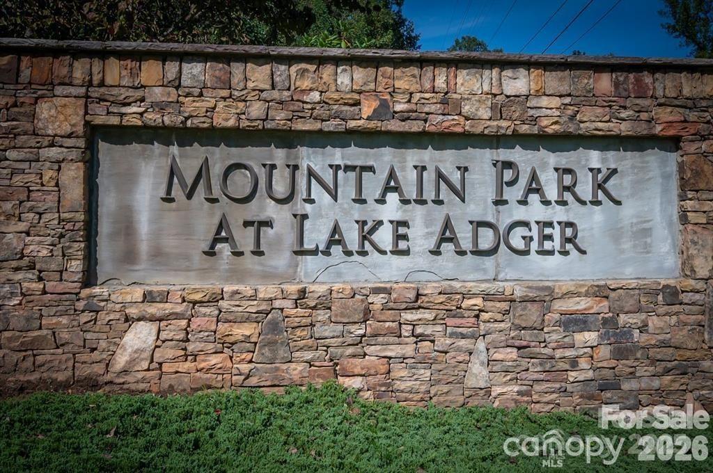 Great lot located in the Mountain Park community of Lake Adger. Lot features great long range mountain views from the top of the lot and views of Lake Adger; building with appropriate trimming will create breathtaking views. Paved driveway to top of lot. Serene waterfront access by private deeded boat slip located just blocks from this lot at marina which has a sign on a stone column accessed by main road just past gated entrance on left.  Marina and boat slip just renovated/rebuilt and in like new condition.  Lake Adger is a private community on a 438 acre lake with 14 miles of shoreline.  Enjoy nature in the tranquility of the neighborhood with walking and equestrian trails and views of Lake Adger, mountains, streams and sunsets.  Lake Adger is a beautiful lake with a hidden waterfall, great boating, swimming, kayaking and fishing.  Limits on the size of motors on boats and no jetskis allowed promotes the serenity of the site. Marina slip fee is appx $90 per year;community well fee appx $120 per year.   Located near Tryon International Equestrian Center, Lake Lure, Hendersonville, I-26 and the Hwy 74 bypass with a short drive to Shelby and surrounding cities.