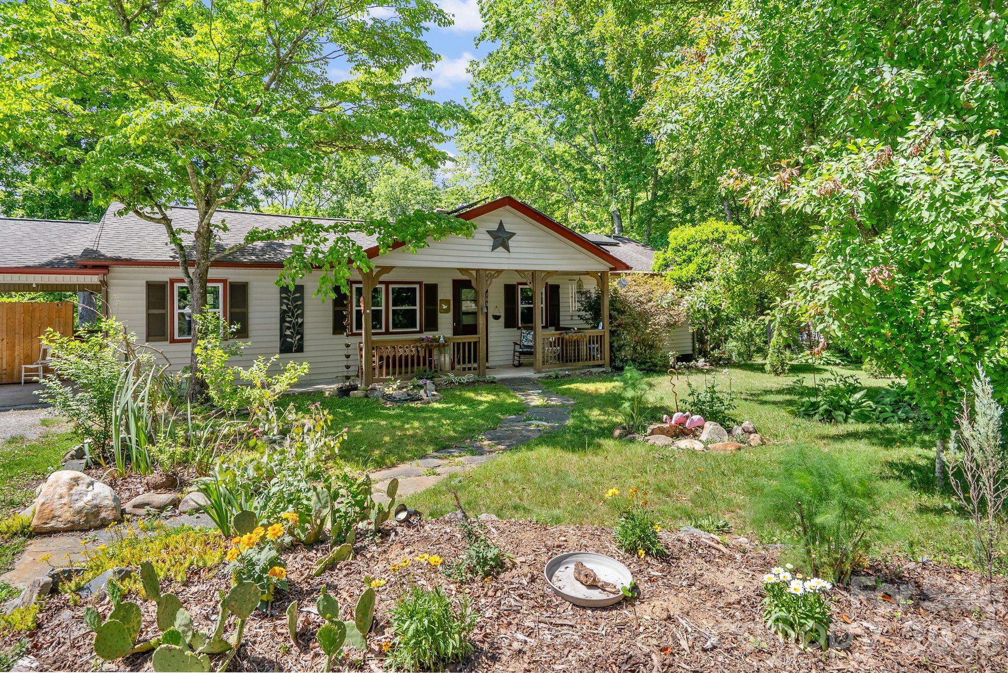Special opportunity in Black Mountain that you won't want to miss! Well cared-for & thoughtfully-updated home on over 1/2 acre - walkable to downtown! This is a nature-lover's paradise, with mature hardwoods, established garden beds, fruit trees, and a meandering creek near the property boundary. Take a peaceful walk through the stone labyrinth in the side yard, while listening to the birdsong. Relax with friends & family on the covered front porch, around the fire pit, or underneath a shade tree. This private, park-like setting makes you feel like you're living on a country road, but everything the town of Black Mountain has to offer is right around the corner. Take a walk to the farmer's market, stroll on one of the town's greenway trails, or head into town for dinner and live music. Lake Tomahawk, Black Mountain Golf Club, and the parks & trails in Montreat are all right there. The home itself is a classic ranch style on a full unfinished basement, with both interior and exterior access. Updated flooring, open concept living area with a bright spacious feel, remodeled kitchen & bathrooms, and thoughtful artistic touches throughout. All updated windows, high-end Bosch heat pump, whole-house water filtration system, and extensive solar array that keeps power bills to a minimum. Basement level provides ample space for a workshop, art studio, or just an abundant amount of storage. Sweet back deck, large garden shed, and carport off the kitchen for covered parking or additional outdoor living area. It's very rare to find a property like this within such close proximity to town. Truly a must-see!