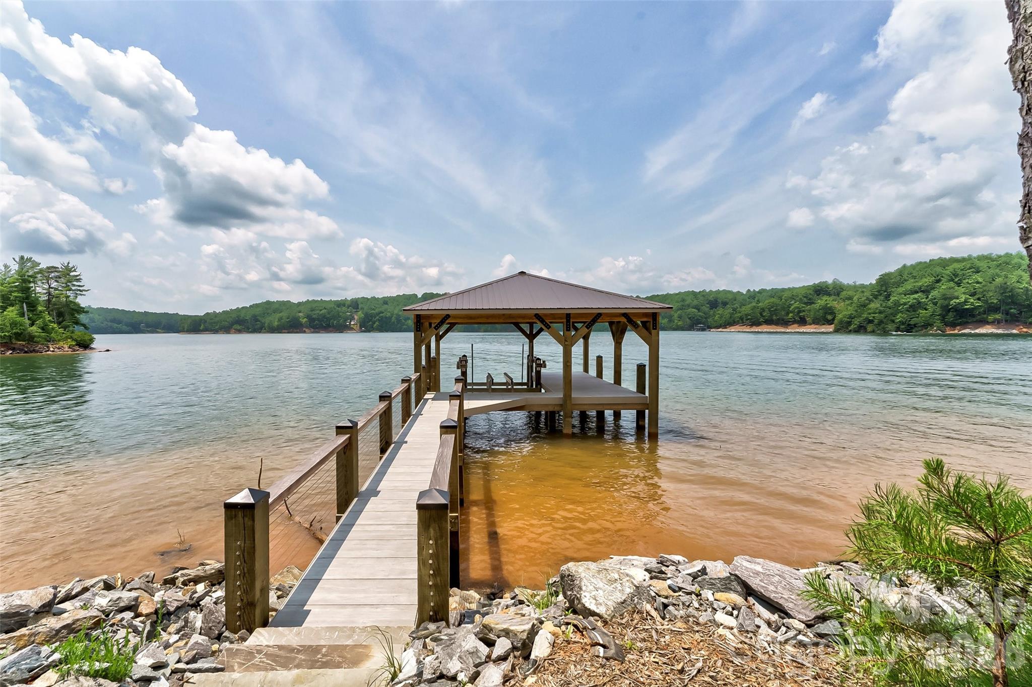 Located in the exclusive Old Wildlife Community, this super flat 7-acre point lot with 1500' of stabilized shoreline allows for a private family compound with main house and up to 3 guest houses. Over $650,000 worth of dock and shoreline stabilization is complete, including a 10,000 lb lift, making the dock ready for your boat and gives instant accessibility to Lake James. Includes membership to Camp Lake James with its Social Hall, pool, hot tub tennis & pickleball courts & fitness center. Easily accessible from Interstate 40, midway between Asheville and Charlotte and within an hour of snow skiing and the high country in Blowing Rock and Boone NC. Breathe in the mountain air & enjoy the beauty of a walk through the pine & hardwoods, or lounge on the fixed pier covered dock allowing direct access to the crystal clear waters of Lake James. Spend the day floating, kayaking, paddle boarding or power boating on this unspoiled lake. Grab your hiking boots and call for your private viewing of this special property today!
