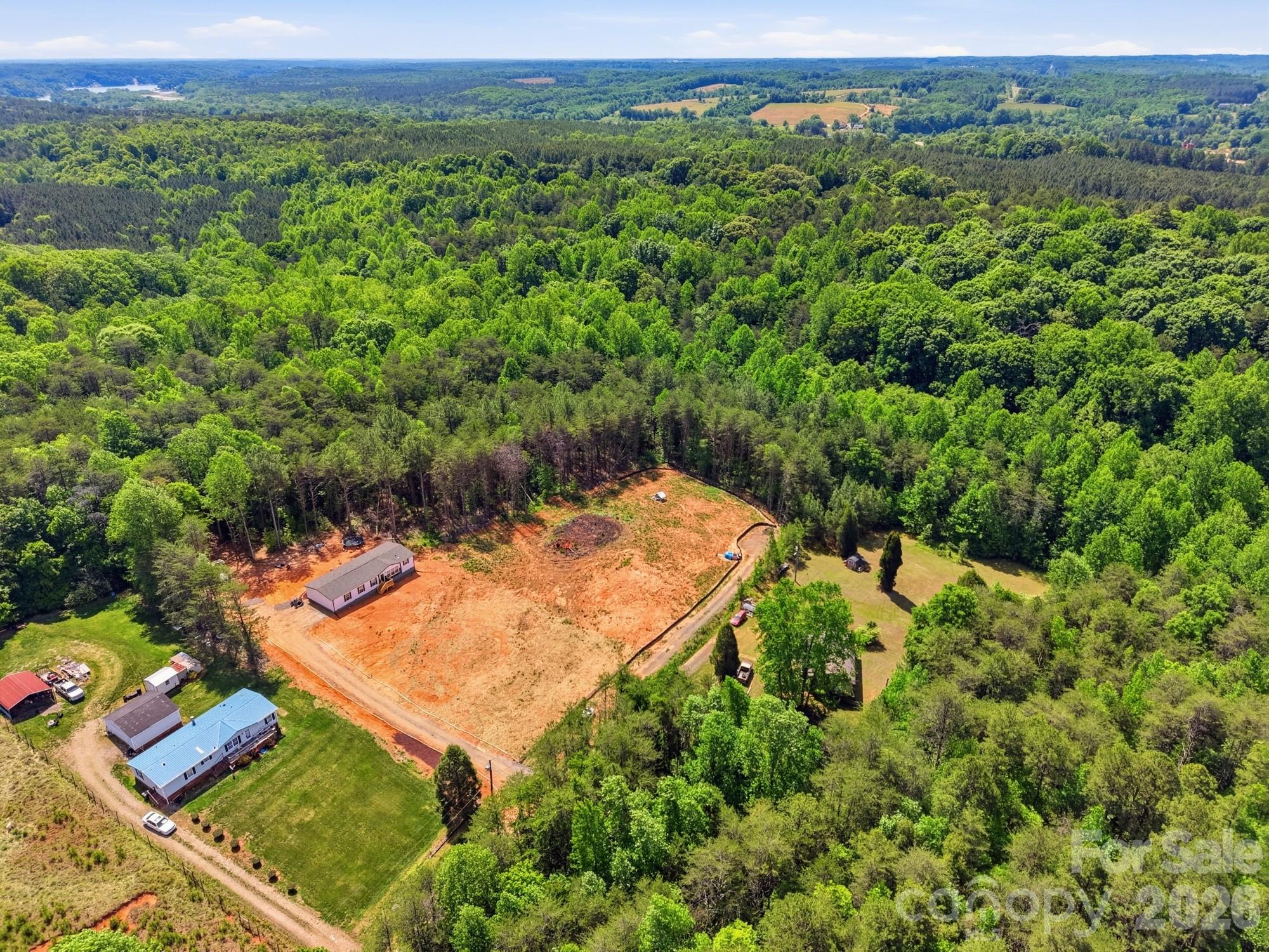 Partially cleared, unrestricted lot at the end of a road. Property accessed by a deeded easement. Septic permit for a 4 bedroom house already in place. Manufactured homes and modular homes allowed. Horses allowed.