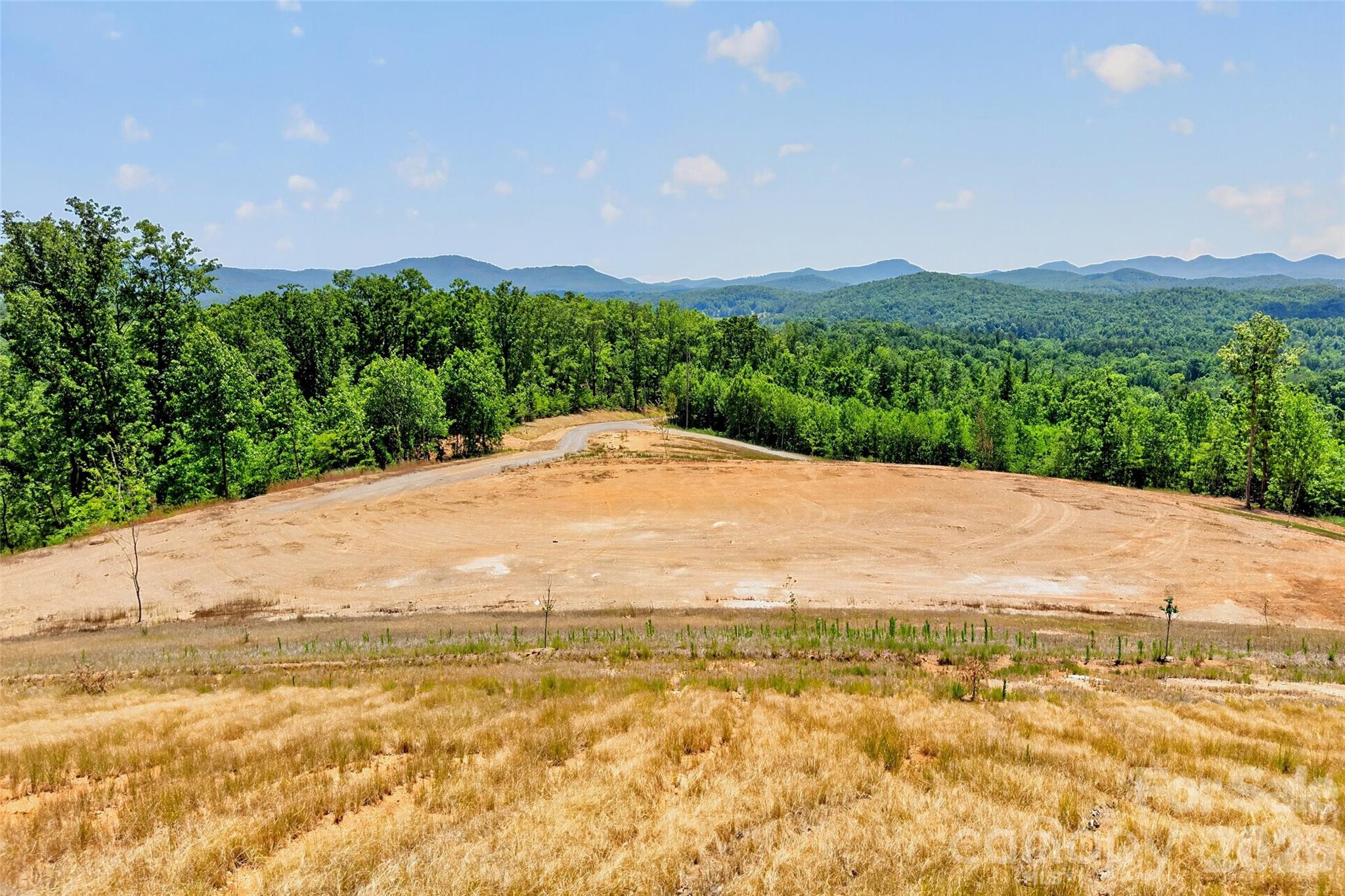 33± acres of opportunity with stunning mountain views and endless potential! This versatile property offers 300 degree views and has already been perc tested, hydro seeded, graded, and cleared for a 3-bedroom home, with septic and well permits making it ready for your vision to come to life. Whether you’re looking to build a private estate, create a multi-family retreat, develop investment properties, or explore commercial possibilities, this property offers flexibility rarely found in such a prime location. Conveniently located just off I-40 and less than 10 minutes from town and the hospital, you’ll enjoy easy access to shopping, dining, and amenities while still experiencing the peace, privacy, and tranquility of mountain living. Don’t miss this rare chance to own a beautiful piece of land with breathtaking views and unlimited possibilities. The area shown in the map is an estimated line based off of a pervious survey. The seller will get a servey done before closing.