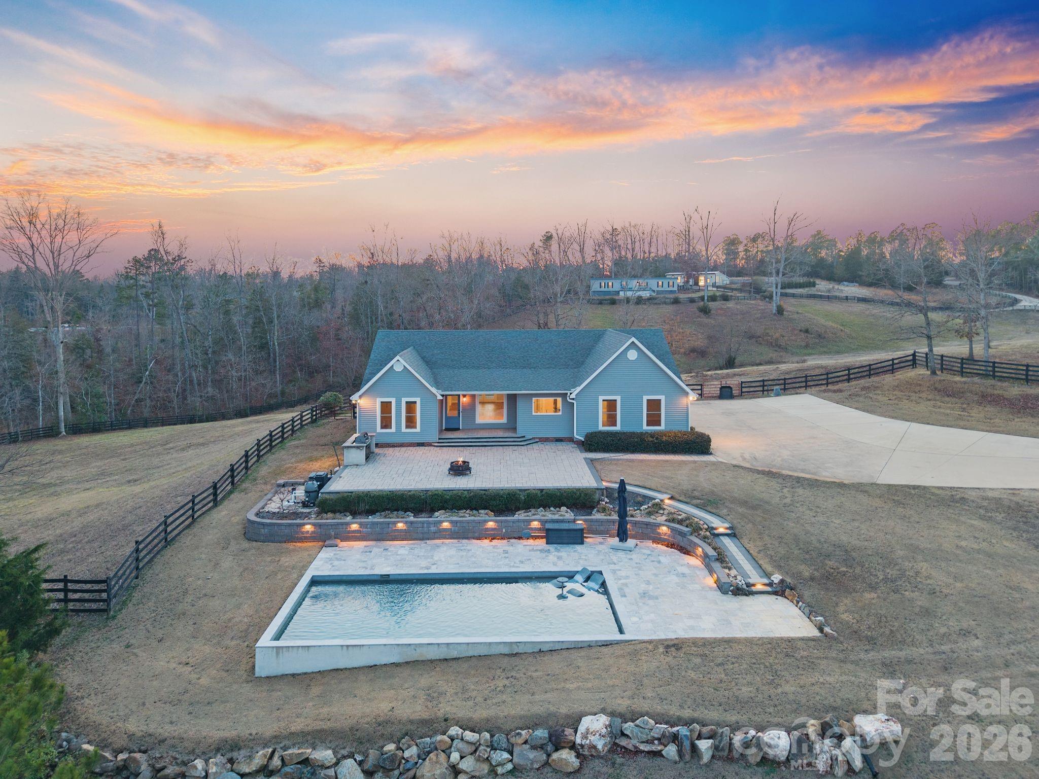 PUBLIC REMARKS:

Horse Property Goals, Unlocked:

Set on 12.83 rolling acres with sweeping views of Lake Caldwell, this equestrian estate is the total package—designed for horse people who want it all. Ride, train, and entertain from your own backyard with a 60’ x 120’ arena, a 4-stall shed row barn with tack and feed storage complete with power, water! The front & rear overhangs coupled with numerous fans, create that perfect airflow and shade for your equine friends.  The ample tractor, equipment and hay storage in the 19’ x 24’ detached garage with large overhang is an added bonus for your farm needs. Two lush pastures are enclosed with 3 board fence with ample water spigots. 

 The main home, remodeled inside and out in 2020, overlooks the lake with a heated inground gunite saltwater pool surrounded by a spacious pool deck and patio with a built-in natural gas grill, setting the stage for effortless entertaining and unforgettable sunset evenings. The rear of the home features a back deck with pergola, the perfect spot to sip your coffee while watching horses graze in the pastures or watching your dogs play in the fenced in backyard. The interior is thoughtfully designed with quality finishes such as custom cabinetry and beautiful millwork throughout. All closets have California closet systems installed for an extra touch of luxury.  Large mudroom for those dirty days working on the farm. Dining area is spacious enough for a large dining table for your family meals, with a nice open flow to the living area. Kitchen appliances are like new, including a gas range for your chef of the family. 

A 1,200 sq ft guest house offers ideal space for trainers, caretakers, multigenerational living, or income potential. This home was built in 2020 and completed with front and back composite decks for relaxing and less maintenance. 

 The massive 2534 sq ft climate-controlled workshop is a standout—complete with an entertainment room, kitchenette and two half baths. The perfect man cave, multi purpose hobby shop or working farm office. Wired with 220 AMP power and plumbed for hot and cold water, this building is perfect for its next job whatever it may be!

Behind the shop you will find the 60' x 120' sand arena with board fencing where onlookers can watch on from the observation deck or from inside the entertainment room.

For those dreaming of a self-sustained farm lifestyle, the homesteading amenities are exceptional: a 28’ x 20’ wired and plumbed greenhouse with raised beds and planting tables, a thriving garden area with numerous outdoor raised beds, fruit trees, and an 8-foot deer fence—ready for year-round growing.

Add in a boathouse and dock, gated entry, fully concrete driveway, and NO HOA, and you’ve got a property that works as hard as you do while living like a private retreat.

Ride & Train at home. Grow your own. Entertain in style.

This is the kind of place equestrians or farm dreamers wait years to find.

*** Lake Caldwell is currently drained by the City/County. Discussion for repair and restoration are in the works.