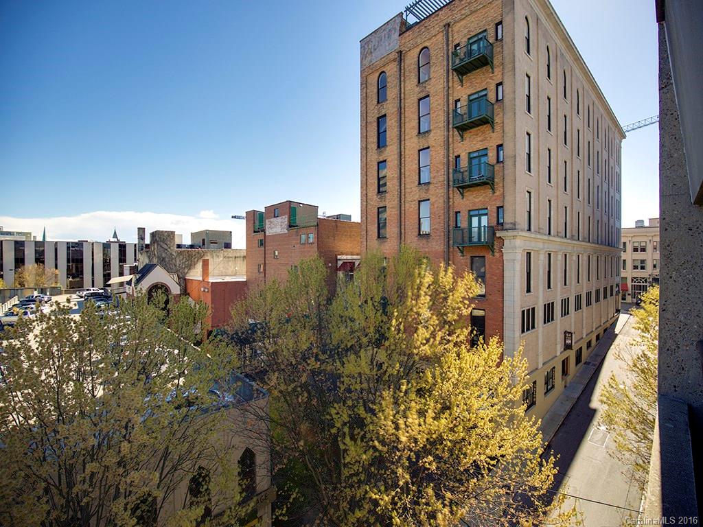 Gorgeous updated unit in popular Penny's Building. 12' ceilings. 9' windows. Gas log fireplace, new stainless kitchen appliances including gas range. Steam shower in second bath. Tile and heart of pine wood floors. Private balcony off master bedroom. Custom closet systems in 3 walk in closets. Great building & neighbors!