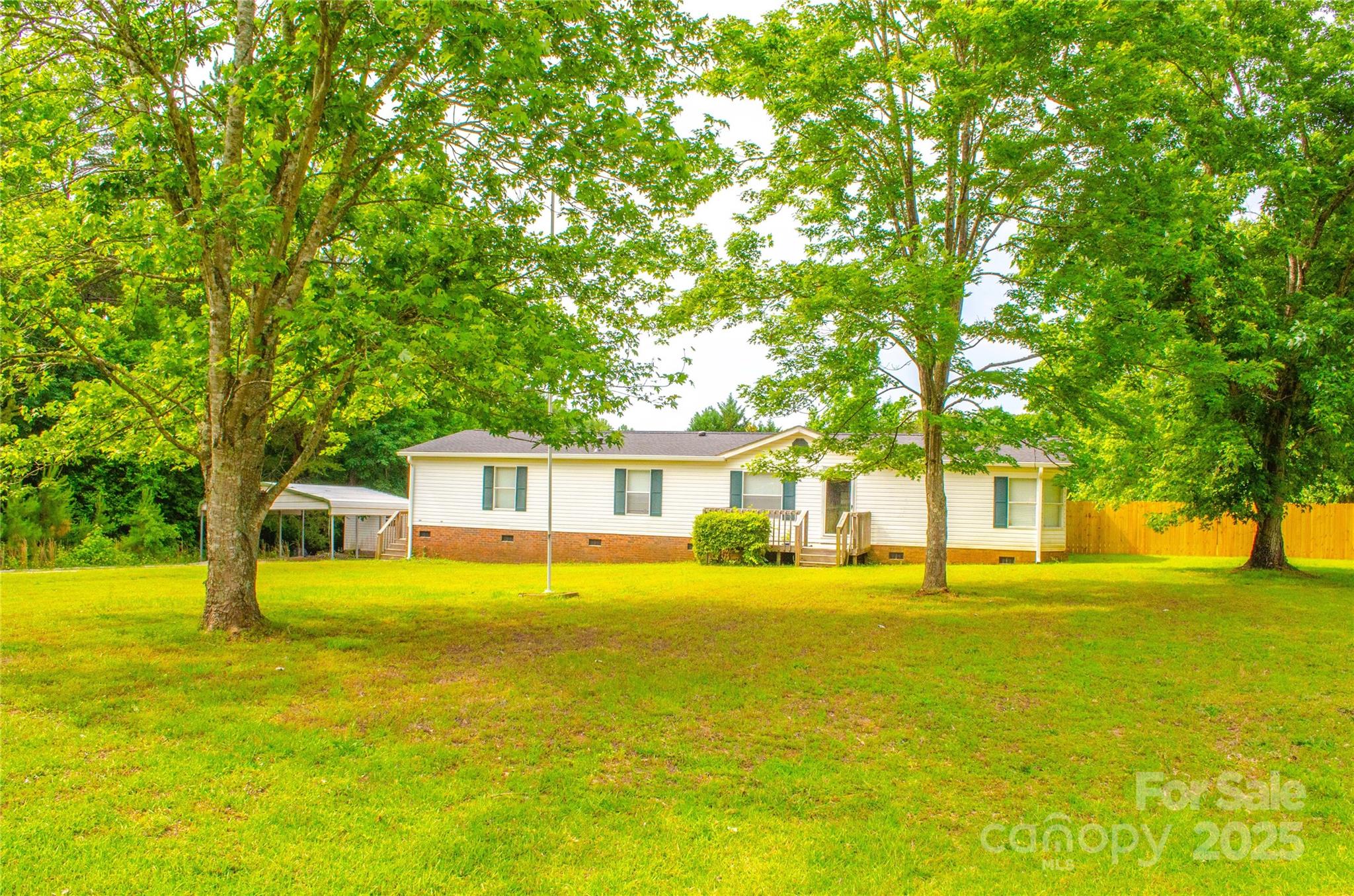 BACK ON THE MARKET WITH A NEW PRICE!! Charming 3 Bed, 2 Bath Home on 1.76 Acres – York, SC
Escape to peaceful country living with this well-maintained 3-bedroom, 2-bath doublewide home offering 1,740 square feet of comfortable space. Situated on a generous 1.76-acre lot, this property combines privacy, open space, and convenient access to downtown York.
Step inside to an open floor plan featuring a spacious living area, a dedicated dining space, and a functional kitchen with ample cabinet storage and a center island—perfect for daily living or entertaining guests. The split-bedroom layout offers added privacy, with a large primary suite that boasts a walk-in closet and a private bath complete with a soaking tub and separate shower.
Out back, you'll find a fully fenced-in backyard with a privacy fence—ideal for pets, kids, or simply enjoying your own quiet retreat. Solar panels installed in 2018, new roof and gutters. Storage building and carport