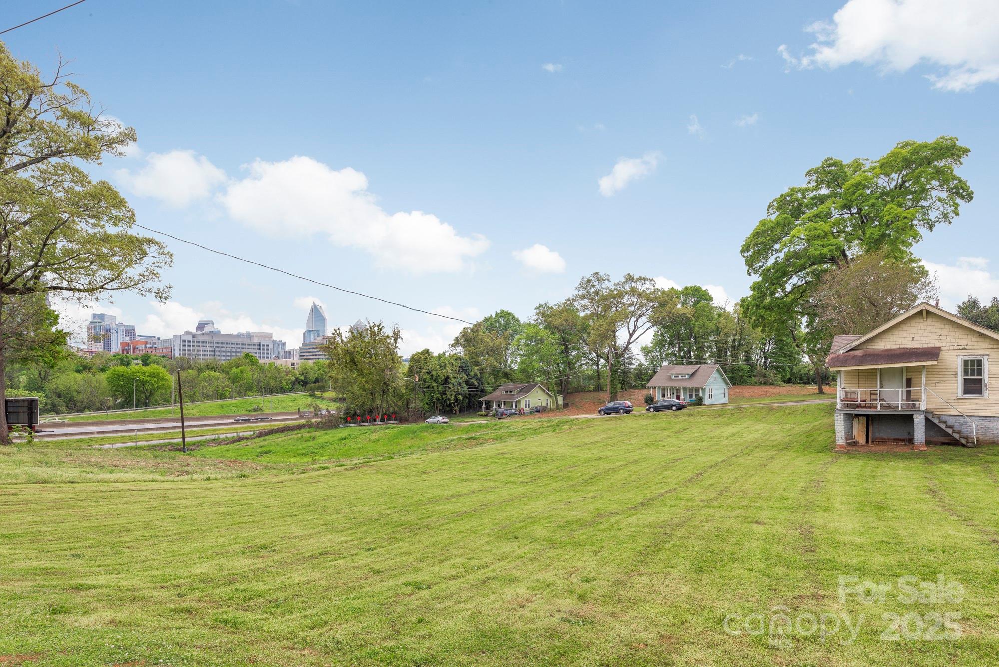 Development Opportunity in Historic West End with unobstructed Uptown Charlotte skyline views.  High visibility location just outside of Uptown and fronting I-77.  Listing includes 13 parcels totaling ~2.28 acres at dead end of W 6th Street.  Mix in the adjoining alleys and street ROW for a total of ~2.83 acres.  Current zoning is a mixture of N2-B and CG.  Parcel Numbers include 07817125, 07817210, 07817209, 07817126, 07817208, 07817127, 07817207, 07817128, 07817206, 07817211, 07817212, 07817213, 07817214.  Three single family homes and one billboard on property.  Please do not disturb tenants.  Land has a terraced topography with some flood zone at the bottom of the street.  Listing agent has ownership interest.