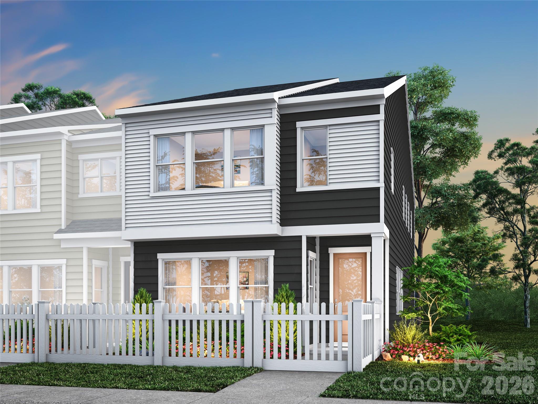 Light-filled living and thoughtful design define this end-unit home at Ellis Townes. Located at 8402 Discovery Lane with an anticipated move-in of September 2026, this residence pairs everyday comfort with elevated style. A fenced front yard creates a welcoming first impression and offers an outdoor retreat, while the 2-car rear-load garage keeps the streetscape charming and uncluttered. Inside, oak box stairs and additional kitchen cabinetry set the tone, where dual-toned cabinetry with crisp white perimeter cabinets paired with a warm light brown island creates a kitchen that is as beautiful as it is functional, finished with white quartz countertops, a GE 30" electric range, and a large single-bowl stainless steel sink. The primary suite is designed as a true retreat, featuring warm brown cabinetry with white quartz countertops and a shower with a built-in seat, tiled walls, and a tiled floor pan for a refined finish.