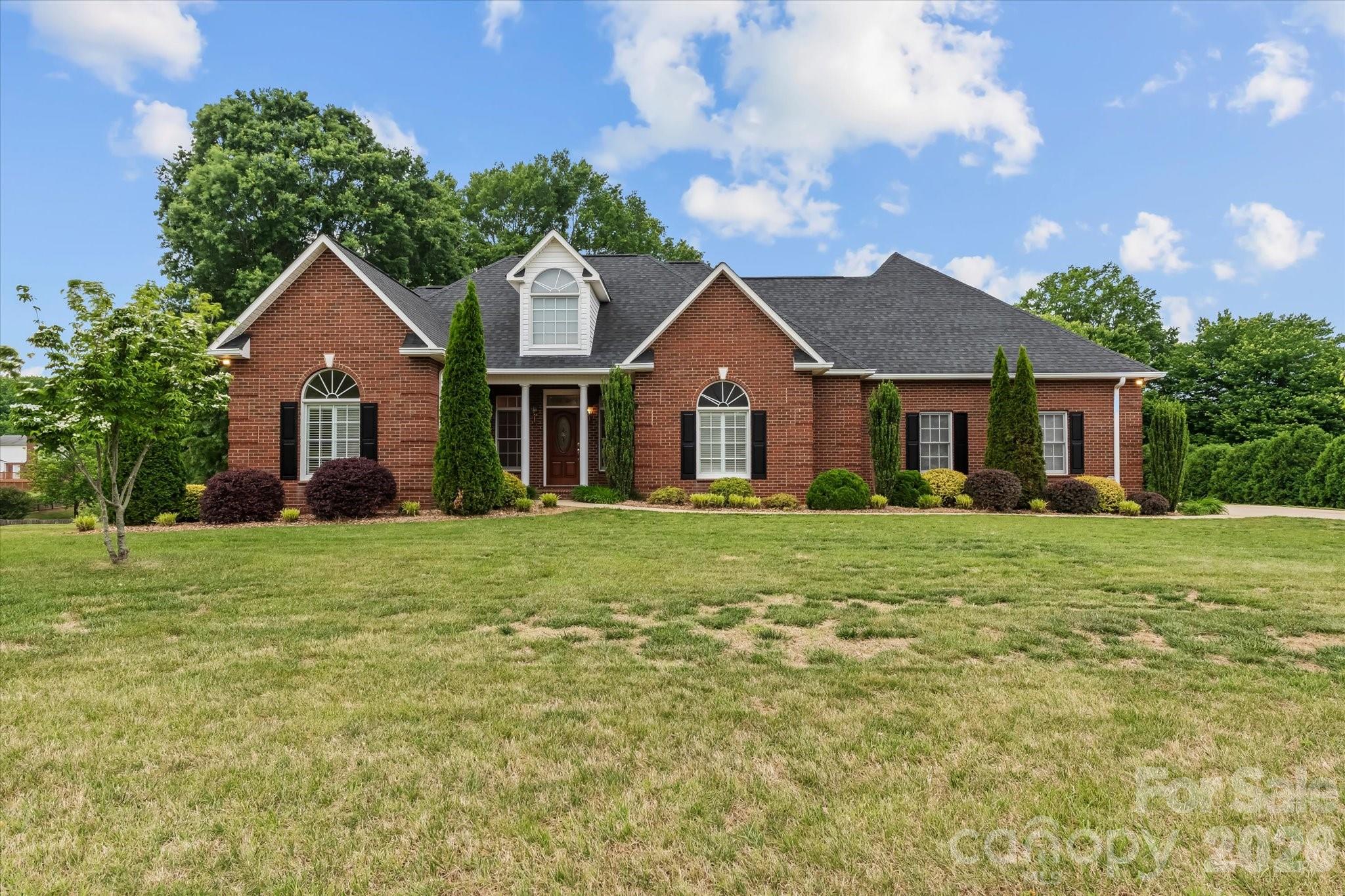 Now with a $45,000.00 price adjustment! Nestled in the Baymount Meadows subdivision, where pride in ownership is evident throughout, this beautifully maintained all-brick home offers the perfect blend of luxury, comfort, and timeless appeal. Designed with a sought-after split-bedroom floorplan, the spacious primary suite serves as a private retreat featuring an ensuite bath, walk-in closet, and direct access to the back porch—ideal for enjoying quiet mornings or relaxing evenings. Three additional bedrooms provide flexibility for family, guests, or a home office.

Elegant details greet you throughout the home, including a formal dining room accented with hardwood floors, crown molding, chair rail, plantation shutters, and a stunning Palladian window that fills the space with natural light. The spacious kitchen is both functional and inviting, complete with granite countertops, tile backsplash, under-cabinet lighting, and a charming breakfast nook with bay window overlooking the backyard.

The welcoming living room offers a warm and cozy atmosphere with a gas log fireplace, French doors, and ceiling fan, creating the perfect setting for gathering with family and friends. Downstairs, the expansive 1,275 square foot finished basement features brand new 2026 LVP flooring, an additional gas log fireplace, and a half bath, making it an exceptional space for entertaining, recreation, or a private getaway. A large unfinished storage room provides abundant extra storage and is not included in the heated living area total.

Thoughtfully updated for peace of mind, this home includes an architectural roof replaced in 2021, Rheem HVAC system installed in 2019, tankless instant whole-house water heater, security system, and a side-load two-car garage.

Enjoy the charm of a golf cart-friendly neighborhood with the added benefit of an inactive HOA and no HOA dues. Residents also have the option to join “The Statesville Swim Club” neighborhood pool for just $475 per household annually.

To make this exceptional property even more attractive, the seller is offering $5,000 toward buyer closing costs, rate buydown, or other buyer needs. This is a rare opportunity to enjoy refined living in one of the area’s most welcoming communities.