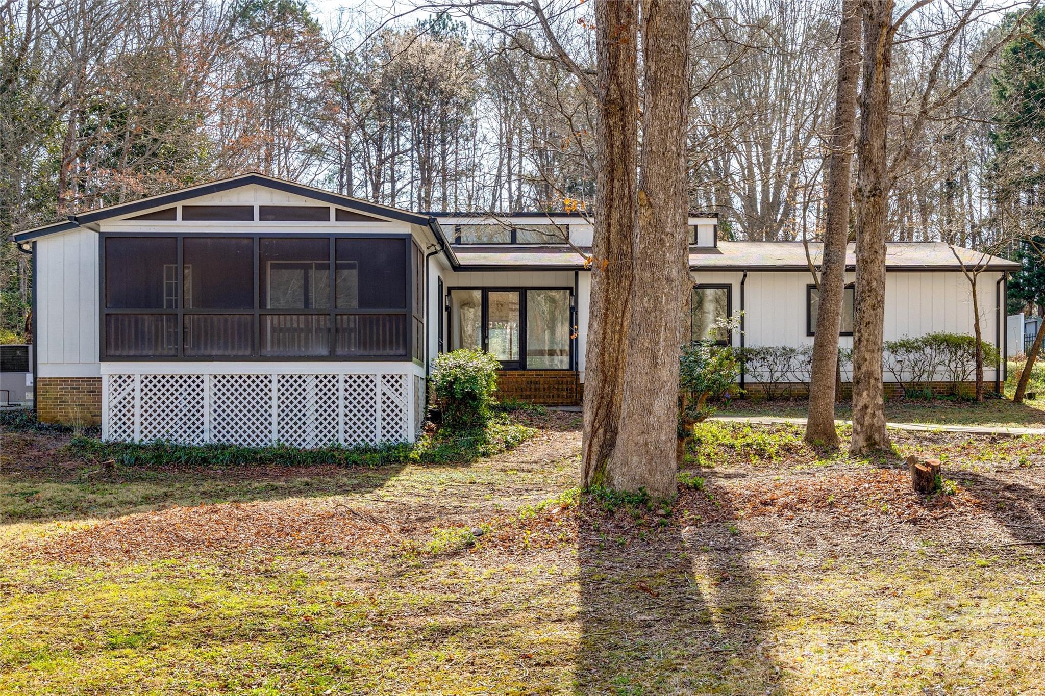 This mid century modern ranch is a gem waiting for you! Within the last year, it's received some amazing upgrades including fresh exterior and interior paint, LVP flooring, new duct work, upgraded lighting, stainless steel appliances in the kitchen and so much more! Step inside and you'll be greeted by custom built-ins and charming wooden beams that add character and warmth to the space. Cozy up by the brick wood-burning fireplace in the family room or unwind on the screened porch in front, or the deck out back, overlooking your private backyard. The expansive floor plan lends itself to endless possibilities offering versatility in every space. This is a fantastic central Rock Hill location! Less than 10 minutes away from the growing downtown area, with a great variety of dining and retail. Plus, you're perfectly situated between several recreational parks like Riverwalk and Cherry Park, offering endless opportunities for outdoor fun and relaxation.