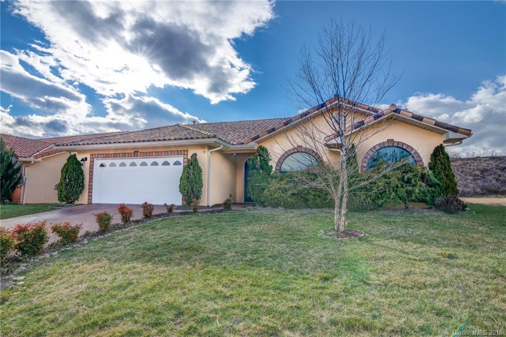 Tuscan design brings Mediterranean charm to this modern, sleek interior. This lock and go community has lawn care included for easy living. Set apart with full glassed Carolina sun room and dining room overlooking fenced private yard. Chefs kitchen with granite, glass-tiled back splash, and full set of appliances. This home inspires you from artist fireplace , interior archways, cathedral ceilings, and stone accent windows. Mountain views and sidewalks in neighborhood.  One not to be missed!