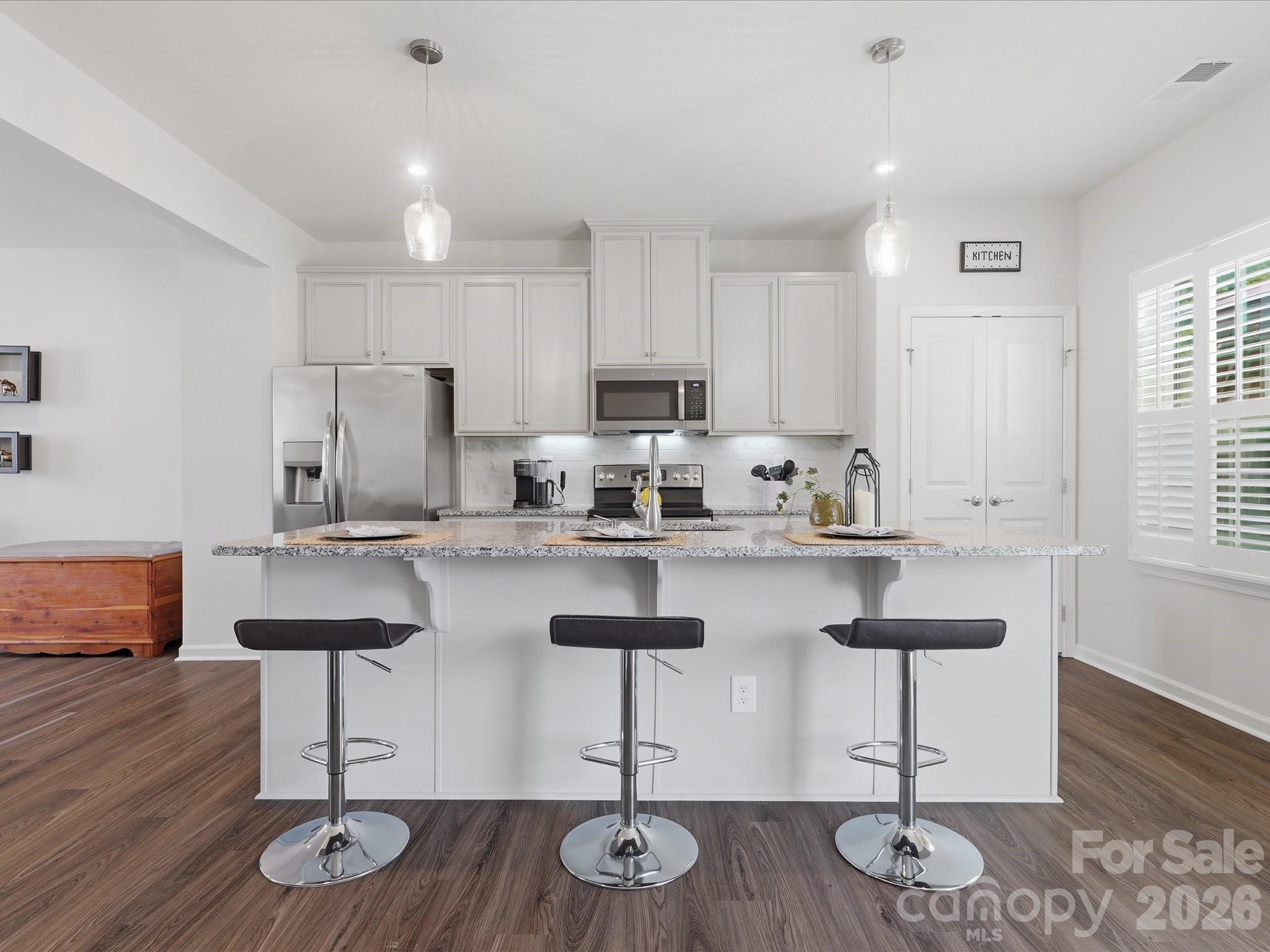Unbeatable value meets waterview tranquility! This move-in-ready, 3-level townhome offers premium features without the hefty price tag. Located in Grantham Place of Regent Park, your commute stays easy and your home still feels like an escape.  The neighborhood offers wonderful amenities including walking paths, community pool, exterior maintenance, pickle ball and tennis courts, playground, and front gated community so you don't have to lift a finger and get to enjoy resort-style living. So what's the real difference from the average townhome?  You're not staring at your neighbor; you have a lovely water view right outside plus direct access to the trails when you need to unwind.  And this townhome is made for having people over: a covered patio downstairs and a pergola setup upstairs that gives you a true outdoor oasis. Inside, the layout gives you flexibility to grow with a flex room on the main floor with access to the two-car garage.  Speaking of parking, this driveway, unlike other townhomes, can actually fit more than two cars in it.  Which means less having to navigate parking schedules and more time to focus on what matters, like taking advantage of the close by dining, shopping, and amusement park. The open living room and spacious kitchen with dining area have room for everyone and still manageable enough of a size you're not dedicated to cleaning 24/7.  The best of both worlds! This gem of a home is stocked with all kitchen appliances to remain. Check out the matterport virtual tour for a real-time walkthrough of the property.