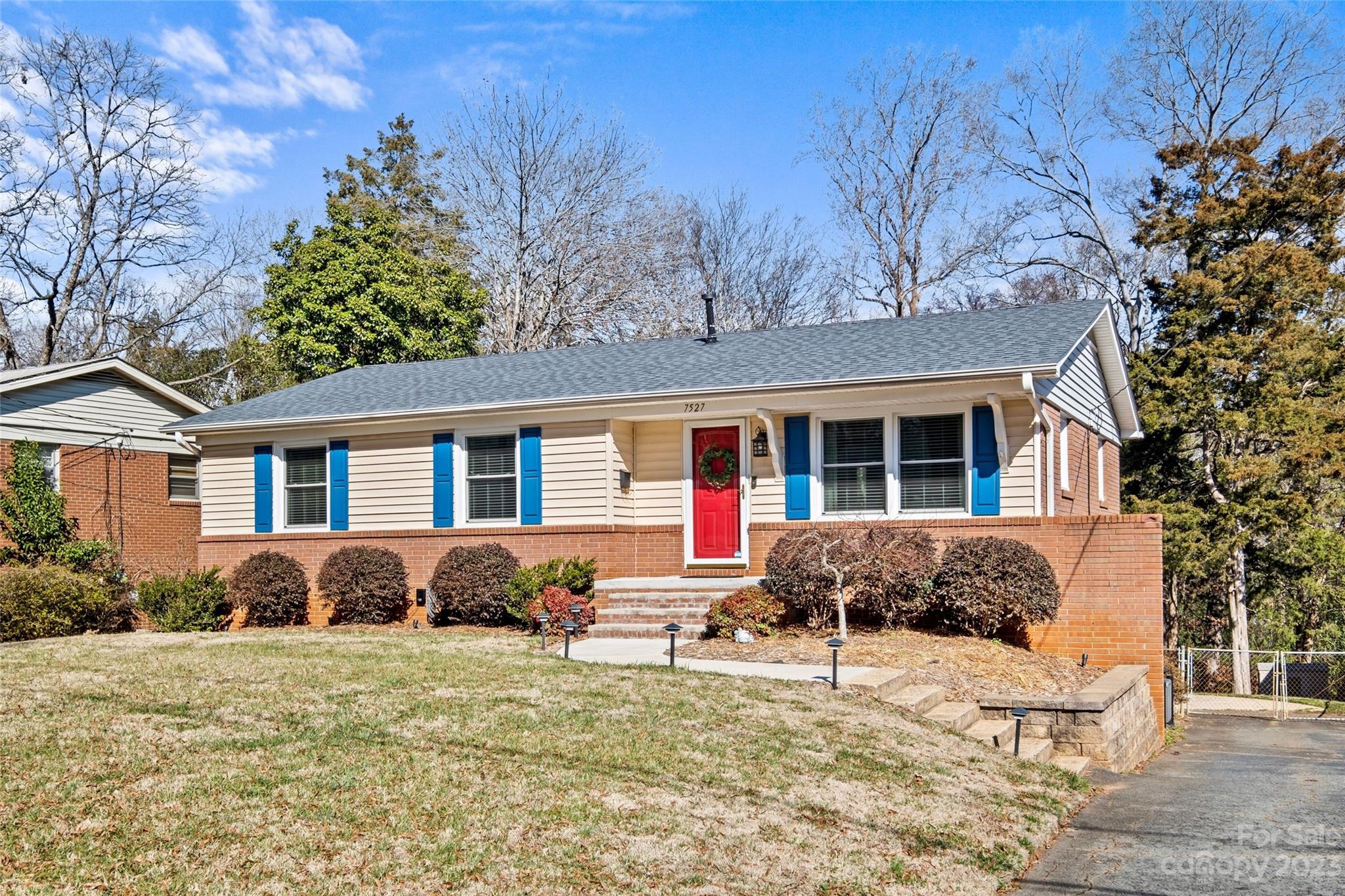 OPEN HOUSES CANCELLED! This adorable, brick ranch home with a basement boasts an array of big ticket upgrades! In 2019, the roof & HVAC units were replaced. In 2020, the gas hot water heater was replaced, and in 2021, new windows & blinds were installed throughout the home. The kitchen features soft close, white cabinetry with under cabinet lighting, quartz countertops, a farmhouse sink, stainless steel appliances, and ample storage. Step out onto the deck to enjoy the view of your 0.46 acre wooded lot with patio below, fire pit space and fenced yard. Lot goes beyond the fence! The walkout basement is comprised of 641 sqft of finished living space with a built-in desk nook, tons of natural light & a powder room. With a 187 sqft, unheated laundry space & 375 sqft workshop/garage, you will have storage options or room to grow! Situated between the Little Sugar Creek Greenway & the LYNX blue line, you have easy access to parks, swim & racquet clubs, public pickle ball courts & more!