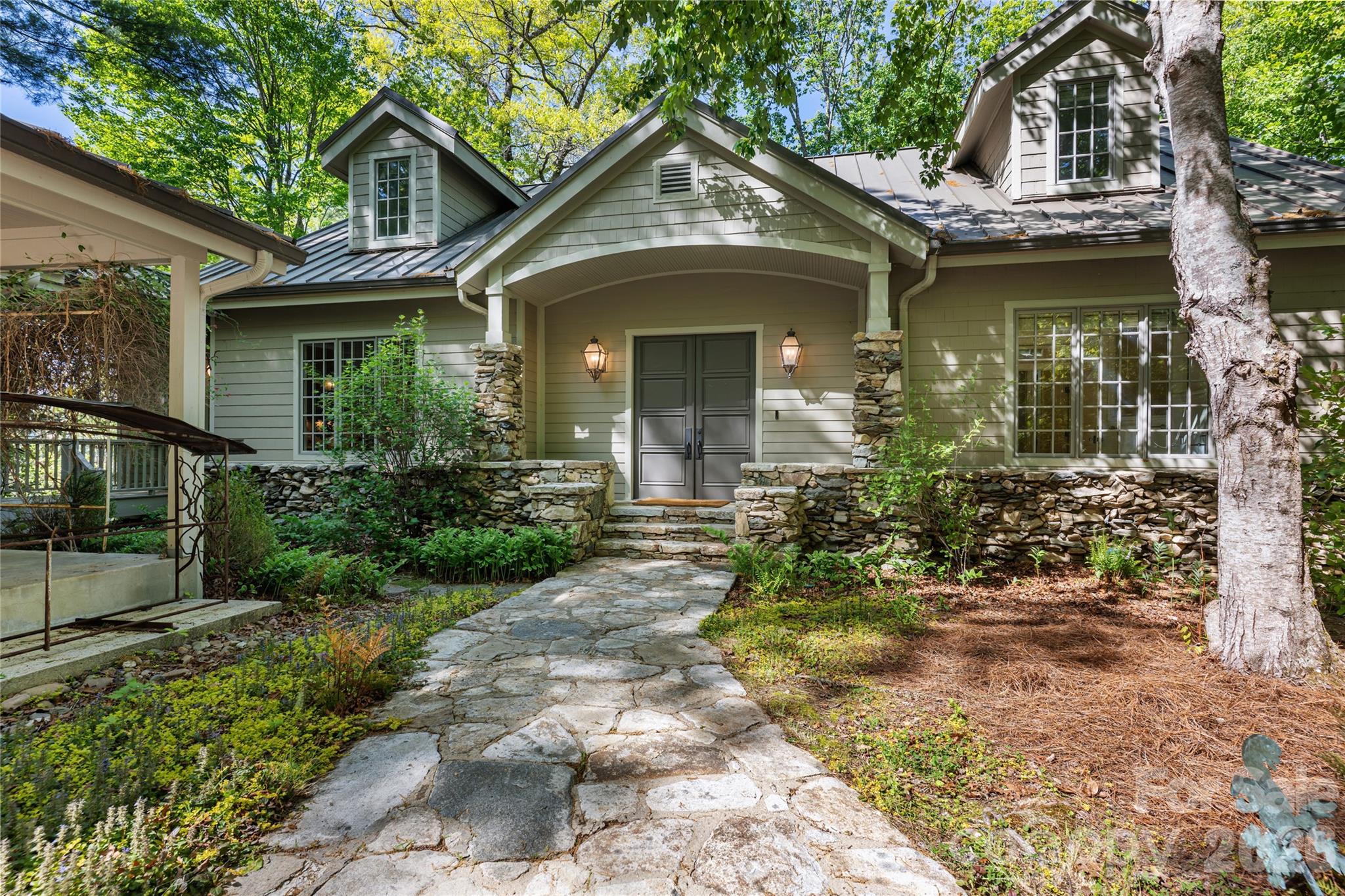 Set along the pristine shores of Lake Toxaway, this exceptional custom home offers a rare blend of luxury, comfort, and breathtaking natural beauty. Featuring 4 spacious bedrooms and 5½ baths, the residence is thoughtfully designed to capture stunning lake views from nearly every angle.

At the heart of the home, a grand great room showcases a striking stone wood-burning fireplace, soaring beamed cathedral ceilings, and a dramatic wall of windows that frame panoramic views of the water. The chef’s kitchen is equally impressive, equipped with a Viking oven and range, multiple dishwashers, a generous island, and even a built-in pizza oven located in the den—perfect for entertaining family and guests.

Designed for both relaxation and convenience, the home includes a private sauna, elevator access, and a whole-home generator for peace of mind. Outside, a circular drive provides easy access, while expansive lakeside porches invite you to unwind and take in the serene surroundings.

The property’s extensive docking and boathouse, connected by a paved cart path from the home, make enjoying lake life effortless. Ideally located across lake from the Club, golf course, and marina, this residence offers the ultimate Lake Toxaway lifestyle—where refined living meets the tranquility of the mountains.