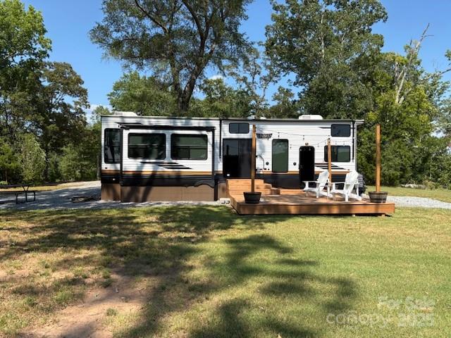 What an opportunity for someone looking for unrestricted land in Polk County. There is plenty of room to build your forever home and still have room for barns and pasture. The property consists of 8.5 acres of unrestricted land, a 2024 Forest River, Wildwood Grand Lodge, small outbuilding with power and lights and 40 foot container. A 3 BR septic system, a 50 gallon per minute well and electric service are already in place. The RV has an on demand water heater, dual A/C, gas fireplace, electric and propane heat and panoramic windows. It is in excellent condition. Most of the property is cleared with some trees. There is lots of road frontage on this corner lot. Conveniently located less than 10 miles from the TIEC and 20 minutes from Forest City and Rutherfordton. There are lots of possibilities with this property. It could be used as a weekend getaway or live in the RV while building your forever home with lots of room for horses. Schedule your showing today.