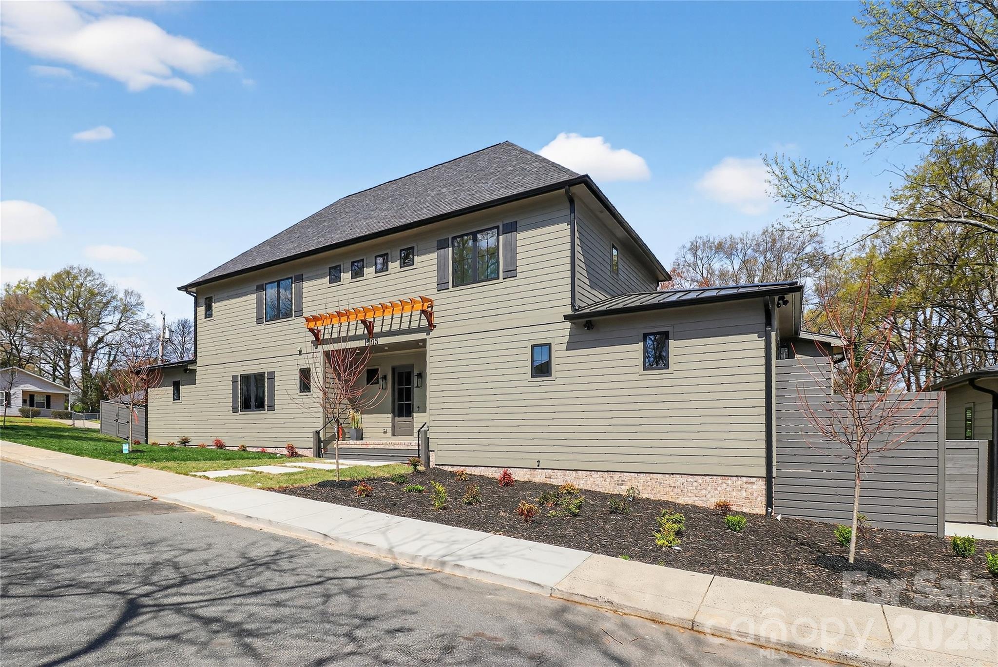 Exceptional two-story home on a prime corner lot featuring a thoughtfully designed floor plan and high-end finishes throughout. Chef’s kitchen showcases a 48-inch dual-fuel range, separate column refrigerator and freezer, quartz countertops, oversized 9-foot island, bar area with wine refrigerator and beverage cooler, and a pantry with ample cabinetry plus prep sink. Open family room leads to a screened porch with privacy screening and fireplace, perfect for year-round enjoyment. Low-maintenance fenced yard adds outdoor privacy. Main level includes laundry with drop zone, a large home office with closet, and a luxurious primary suite with dual sinks, two showerheads, freestanding soaking tub, and an incredible oversized walk-in closet with island and drawer storage. Upstairs offers a second family room/loft, bonus or workout room, and three additional large bedrooms, each with its own en-suite bath. Detached oversized garage with epoxy flooring completes this beautifully appointed home.  This home is move in ready!