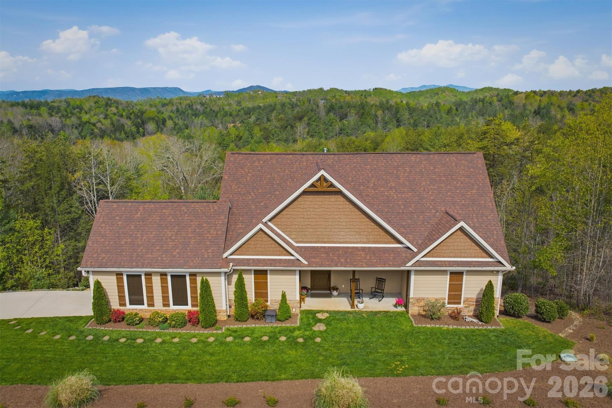 1510 High Valley Way - A rare opportunity to own a custom built, meticulously maintained, 3 BR 2.5 BA home in the South’s premiere Outdoor Lifestyle Community, The Coves Mountain River Club.
On 2+ acres of serene mountain land, this home was planned for enjoying the beauty of the mountains and the comforts of a lovingly maintained home and grounds.

The heart of this home is the great room, featuring a gorgeous, stacked stone fireplace that climbs to the vaulted wood ceilings.  Sunlight streaming through tall windows and French doors creates a vibrant, spacious connection to the outdoors.  Astonishing views of the Blue Ridge Mountains rim the horizon; you’ll savor incredible sunsets followed by stars that go on forever. 

Designed for function and beauty, the kitchen features custom hickory cabinetry, granite counters, under-mounted stainless steel sink, generous island and breakfast bar, 5 burner gas range, under the counter microwave, beverage chiller, wine storage and a large walk-in pantry.  A convenient mudroom+laundry room leads to the garage.

Transom windows atop the primary bedroom and the powder room doors ensure that natural light extends beyond the great room.  Even the powder room is designed for character and style with a copper sink and leathered granite countertop.  

The ensuite primary bedroom, with more amazing views of the mountains, is a personal haven for ending the day with tranquility.    

Upstairs are two additional BR and full BA, connected by a balcony that overlooks the great room below.  

Thoughtful landscape design creates spaces for dining, relaxing, and enjoying the surrounding natural setting, year-round. Follow the path to the backyard oasis where the hot tub spa is tucked away, offering a resort style atmosphere for cool mountain evenings. The grounds are pristine and planted with feature evergreens and blooming shrubs.  The grass looks like carpet.  All this and there are still +/- 1.4 acres of undeveloped woods on the property. 

Your new home includes unparalleled community amenities.  
The Coves Mountain River Club is a 3,200 acre gated community on 5 miles of the Johns River, in the Blue Ridge Mountains of NC. Hike, bike, ride horses, or UTVs on miles of community exclusive trails that weave through.  River access areas are ready for you to put in and take out your kayak, wade and fish, picnic, or gather round a stone fire pit. The crown jewel of The Coves is the magnificent post and beam constructed clubhouse, Pisgah Lodge, located on one of the highest peaks. There’s a saline pool, fitness center, locker rooms, full kitchen, lending library, pool table, fire pits, and porches, overlooks to take in 360º views of the Blue Ridge Mountains, South Mtns, and Brushy Mtns. The Coves is a Firewise USA® Community, a program of the National Fire Protection Association, that helps neighbors organize to reduce wildfire risk, harden homes, and create defensible space by managing vegetation and preparing for wildfires. Garden your private plot at the Community Garden or join your neighbors to care for and harvest the community cooperative vineyard. Pickle-ball and shuffleboard courts, putting green, and a picnic pavilion are located at another Coves's park, Wyatt's Landing. Additional amenities include 2 Equestrian Centers and a Dog Park.  A full calendar of events is planned and there are over 30 clubs to join.  500,000 acre Pisgah National Forest and the Wilson Creek Wild and Scenic River Area are across the road! 1.25 hour drive to Charlotte or Asheville, minutes to Lenoir, Blowing Rock, Morganton, and the Blue Ridge Parkway.

1510 High Valley Way offers a compelling opportunity as a full-time residence, retreat, or second home. Properties offering this level of privacy, outdoor space, and amenities are rare.  Schedule your visit today!