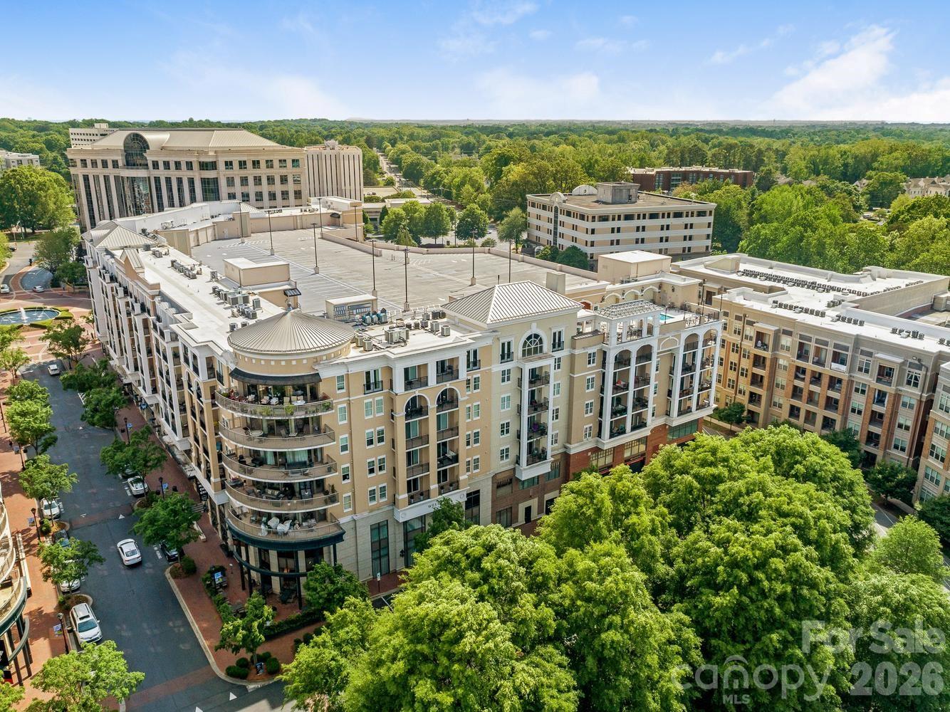 Fabulous one-bedroom condo with great flex space! Kitchen has 2026 appliances, generous counter & cabinet space, under-cabinet lighting & bright pendant lights over the island to make food prep a breeze. The open floor plan offers so many options for furniture configuration-- a spacious living area, a dining area & a bonus room that can be an office, a TV room, a workout space--you name it! The bedroom includes an en suite bathroom with new countertop, stall shower and walk-in closet. Sliding door from the living area opens onto a covered balcony from which you can enjoy a western sunset view. Freshly painted with wood or tile floors throughout, a 2020 heat pump and 2026 water heater, it is move-in ready! Condo comes with one assigned parking space in gated owners' area & seven floors of guest parking--the most in Charlotte. Piedmont Town Center includes on-site restaurants (Peppervine, Bentley's, Duckworth's, Del Frisco's, Leo's, Mal Pan, Tous Les Jours Bakery, Milk Cha-Cha, Summit Coffee), fitness club and personal care venues (hair, nails, lashes, day spa). Welcome home!