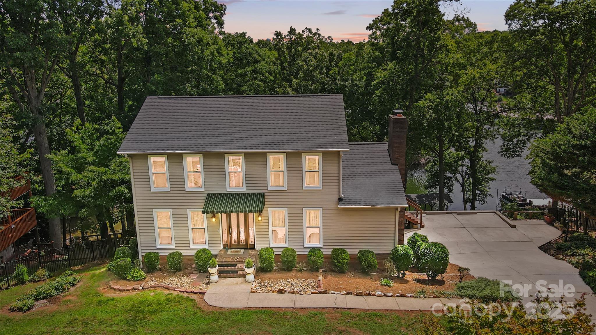 Discover lakeside vacation living at its finest with this two-story waterfront home in Tega Cay. Nestled in a private cove, this tranquil retreat offers an unparalleled escape with relaxing lake views and direct water access. This home offers updated kitchen, bathrooms, newly painted rooms, updated flooring and so much more. The Grandmillennial style offers traditional and charming spaces. Step outside to enjoy both covered and open decks designed for al fresco dining and relaxation. With two docks at your disposal—one for swimming, fishing, and entertaining—you'll have endless options for outdoor enjoyment right at your doorstep. A new staircase provides easy water access, ideal for boating and watersports. Recent upgrades add modern convenience and charm, including double-pane windows at the front, a new dock roof, deck stairs, and a sleek wrap-around cable deck. Don’t miss the chance to own this exceptional lakefront home and experience Tega Cay’s vacation lifestyle every day!