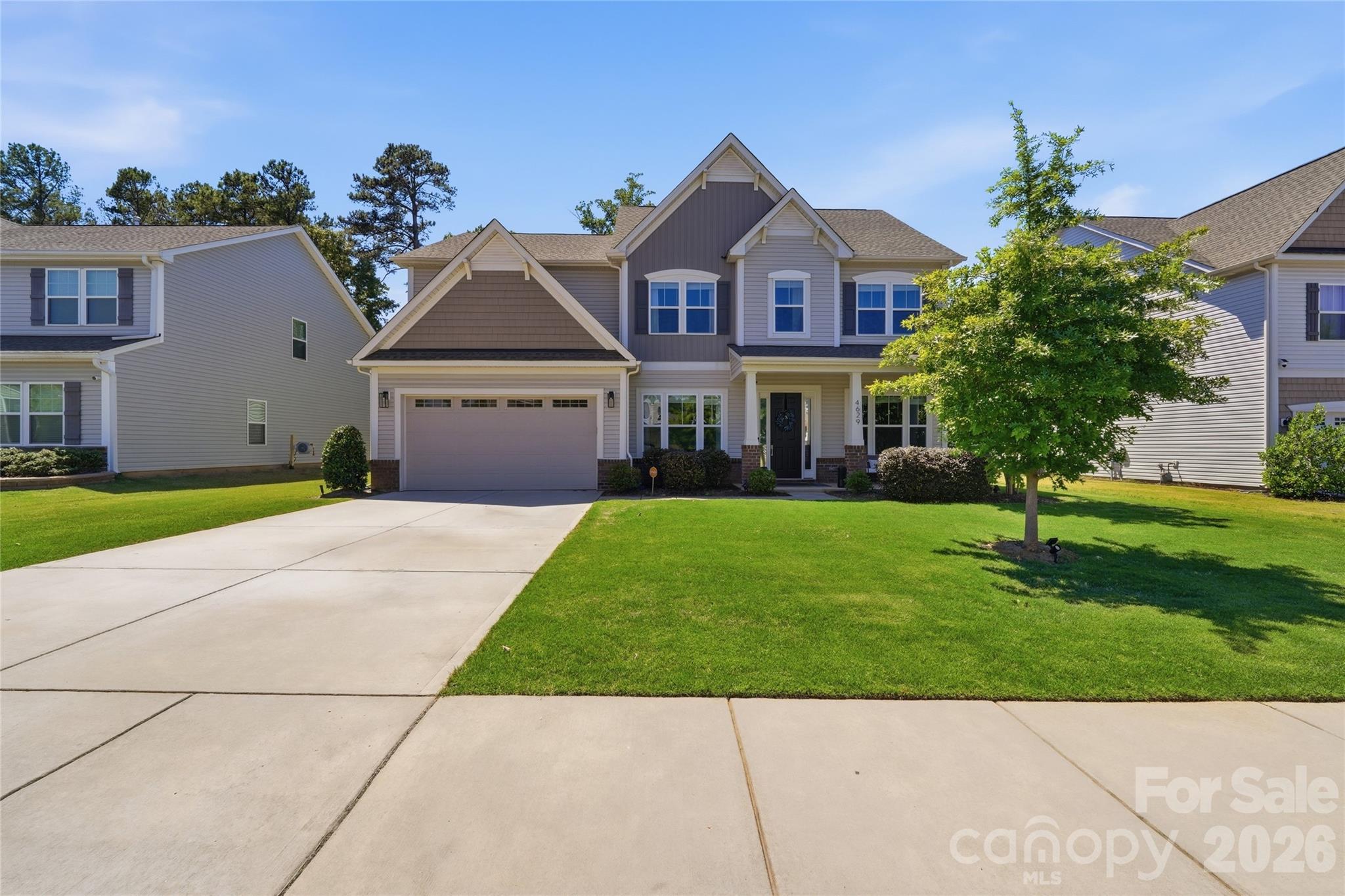 Built in 2021, this stunning 5-bedroom, 4.5-bath home in Prestwick offers over 3,600 square feet of thoughtfully designed living space with modern finishes and an open-concept layout perfect for everyday living and entertaining. The kitchen features abundant cabinetry, expansive counter space, and flows seamlessly into the main living area with a fireplace and natural light throughout. The primary suite provides a relaxing retreat with a spa-inspired bath, freestanding soaking tub, separate shower, and generous walk-in closet. Additional bedrooms offer flexibility for guests, office space, or hobbies. An EV charging station in the garage makes electric vehicle charging convenient for your EV. Step outside to enjoy the large backyard with peaceful views and room to create your ideal outdoor setup. Conveniently located just minutes from Carowinds, I-77, and I-485, this home offers easy access to shopping, dining, golf, entertainment, and major commuter routes while combining comfort, functionality, and style in one exceptional package.