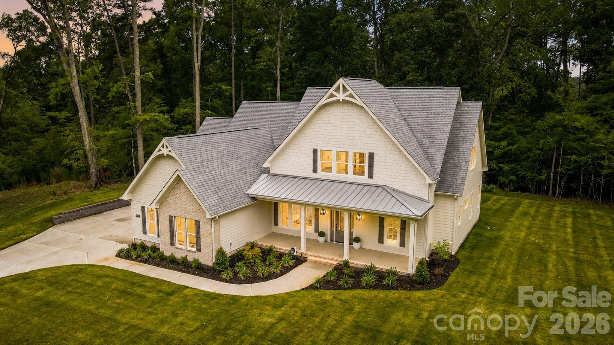 Custom feel without the custom build timeline. Welcome to Southern Pine Lakes, Clover’s newest luxury community featuring just 37 homesites in a top-rated school district. This is a rare opportunity to own a move-in ready home that feels fully custom in one of the area’s most coveted new neighborhoods.

Finally, a home that’s not just another farmhouse! Thoughtful architecture, curated finishes, and distinctive design set this one apart. Inside, gorgeous engineered hardwood floors span the entire main level, leading into a beautifully appointed living space highlighted by coffered ceilings and designer lighting. The chef’s kitchen is the centerpiece of the home, featuring high-end quartz countertops w/ quartz sink apron, glass display cabinetry extending to the ceiling, and a large island perfect for gathering. A servery with additional ceiling-height cabinetry connects seamlessly to the dining area, while a spacious pantry with custom shelving adds everyday functionality.

The spa-inspired primary suite offers a modern yet timeless retreat with a massive double vanity and walk-in shower. The primary closet features custom shelving and a window that fills the space with natural light.

Upstairs provides exceptional flexibility with a large bonus room plus an additional adjoining flex area ideal for a workout space, studio, office, homework zone, or future closet conversion for an additional bedroom. A lofted living area adds even more usable space, while the secondary bedrooms include Jack-and-Jill bedrooms plus an additional bedroom with its own private bath.

Outdoor living is just as inviting with double French doors opening to a private covered back porch, perfect for entertaining or relaxing. The freshly sodded yard with full irrigation provides instant curb appeal and easy lawn maintenance.

The home also features three attached garage spaces (two-car plus an additional adjoining one-car garage) for extra storage or hobby space.

Located just minutes from Lake Wylie and charming downtown Clover, approximately 30 minutes to Uptown Charlotte, and easy access to Charlotte Douglas International Airport, this home offers the perfect balance of peaceful living and convenient access.