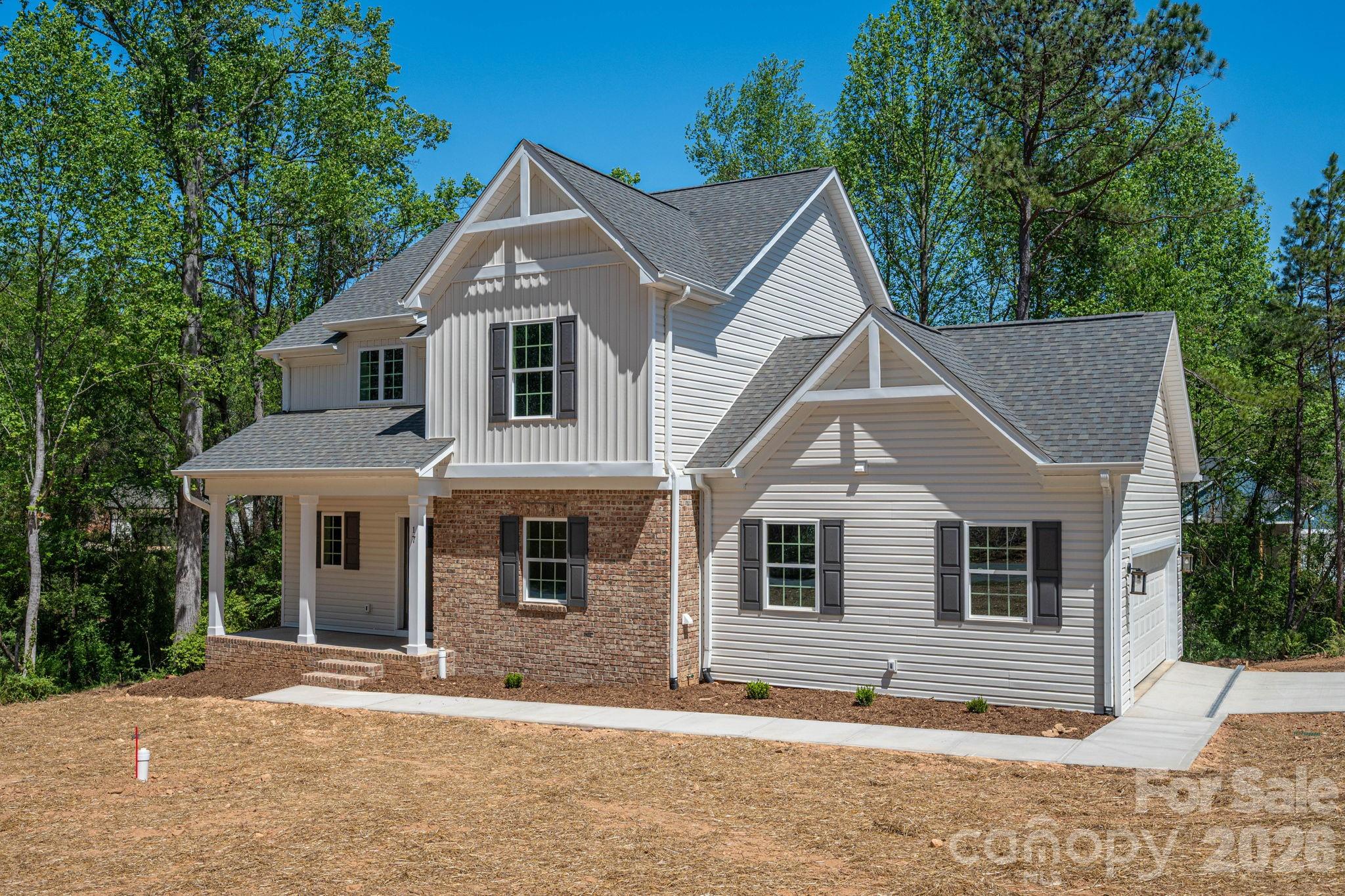 Stunning New Construction Home Near Lake Hickory! SELLER OFFERING $10,000 CREDIT TO BUYER AT CLOSING! This beautiful 3-bedroom, 2.5-bathroom home offers an open floor plan with spacious rooms and plenty of upgrades. From the 100% waterproof luxury vinyl plank flooring throughout the main level and bathrooms to the oak stair treads with black balusters, every detail has been carefully considered. The kitchen boasts solid wood, soft-close cabinets, elegant granite countertops, a stylish tile backsplash, and stainless-steel dishwasher and microwave - open to the dining area and living room making it perfect for both cooking and entertaining. Step out to the deck off the dining area and relax! The primary bathroom features luxurious granite countertops and a large tile walk-in shower, creating a spa-like retreat. The full basement is equipped with a 10" Superior Walls Basement System, offering excellent storage potential or the opportunity to finish for additional heated square footage. There are double doors making golf cart and mower storage a breeze.  The large garage is fitted with a steel back insulated garage door, ensuring durability and energy efficiency. One .year builder warranty
Located just minutes from the serene Lake Hickory, this home is ideally situated for convenience and relaxation. Don’t miss the chance to make this dream home yours! Some photos are virtually enhanced.