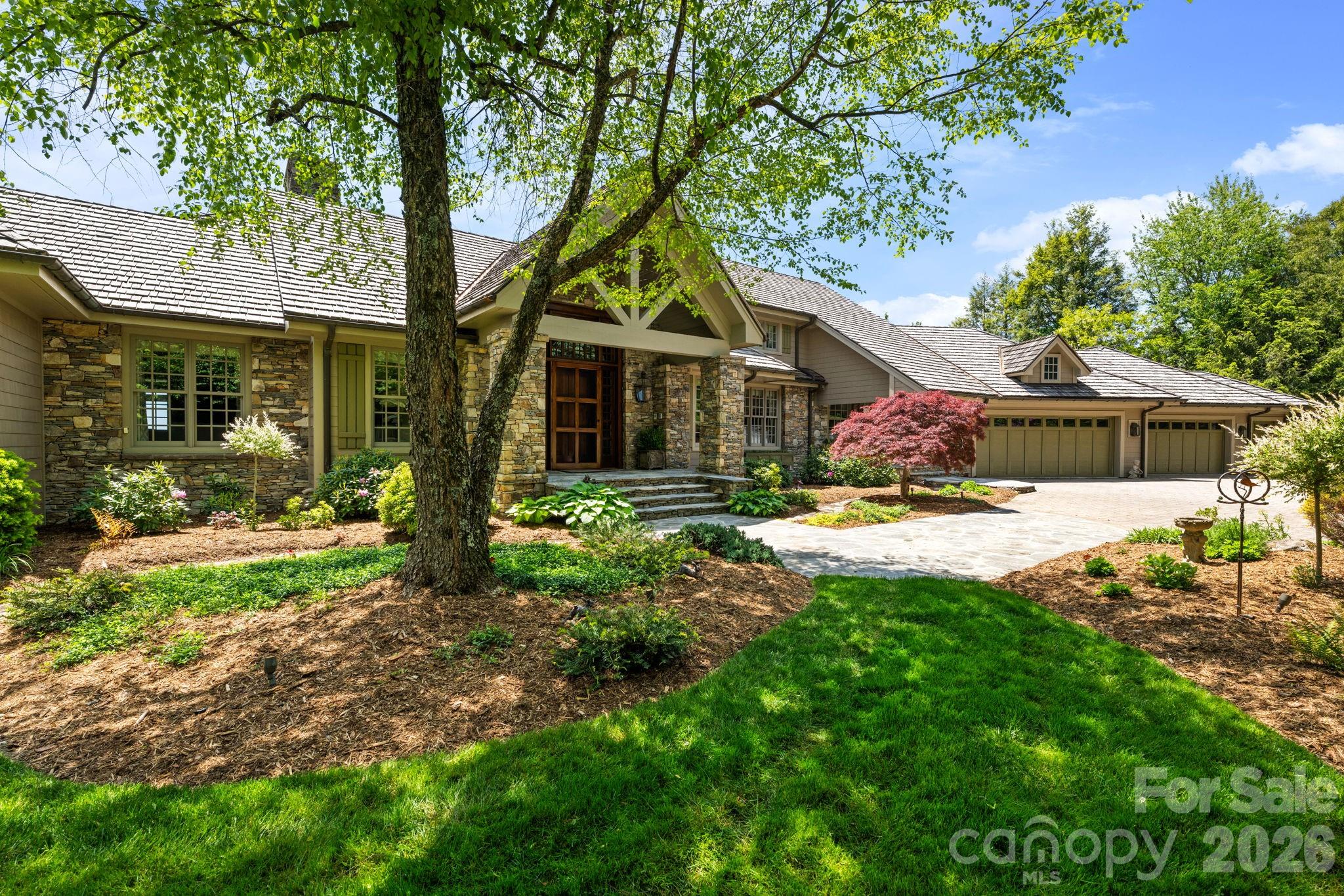 Perched high above the breathtaking Johns River Gorge, this is an extraordinarily rare opportunity to own one of the finest homes on one of the most coveted lots in all of Blowing Rock. Perfectly positioned on iconic Main Street, this exceptional mountain retreat captures the kind of panoramic views most people only dream about — with sweeping vistas of Grandfather Mountain, the Johns River Gorge, and the surrounding Blue Ridge peaks. Built by renowned Enterline & Russell Builders, this remarkable home offers an ideal blend of craftsmanship, privacy, luxury, and convenience — all less than a mile from the Blowing Rock Country Club, golf course, charming downtown shops, restaurants, and The Blowing Rock Art & History Museum. Originally the site of the historic Farm House Restaurant & Inn, this storied property became one of only a select few homesites created to take advantage of this premier location overlooking the Gorge. Today, it stands as an extraordinary legacy property in the heart of the High Country. Inside, timeless mountain elegance meets thoughtful modern updates. The beautifully renovated 2023 chef’s kitchen features custom cabinetry, premium appliances, dual sinks, and two dishwashers — designed for effortless entertaining and everyday luxury. Custom cabinets and doors crafted by Henry Vaughn, hydronic heated floors in the kitchen and primary bath, and beadboard reclaimed from the historic Farm House Restaurant & Inn create a warm sense of character and authenticity throughout the home. The inviting main living spaces and primary suite are rich with texture and craftsmanship, while expansive windows frame unforgettable long-range mountain views at nearly every turn. Step outside to experience cool mountain breezes from the spectacular screened porch, complete with a relaxing hanging bed — the perfect place to unwind and soak in the scenery. Expansive open-air porch areas on the main level and covered porches on the lower level create exceptional spaces for entertaining, dining, or simply enjoying the beauty of the mountains in every season. An oversized 4-car garage plus a separate golf cart garage provide exceptional space for vehicles, mountain toys, and easy trips into town or to the country club. Recent exterior improvements completed by Hibriten Construction include a stunning new cedar shake roof, fresh exterior paint, repairs, and extensive refreshing of the property. Solar panels installed within the last five years help reduce energy costs while enhancing efficiency. Opportunities like this rarely become available in Blowing Rock — an exceptional luxury mountain home with iconic views, rich history, unmatched craftsmanship, and an unbeatable location just moments from everything the village has to offer.