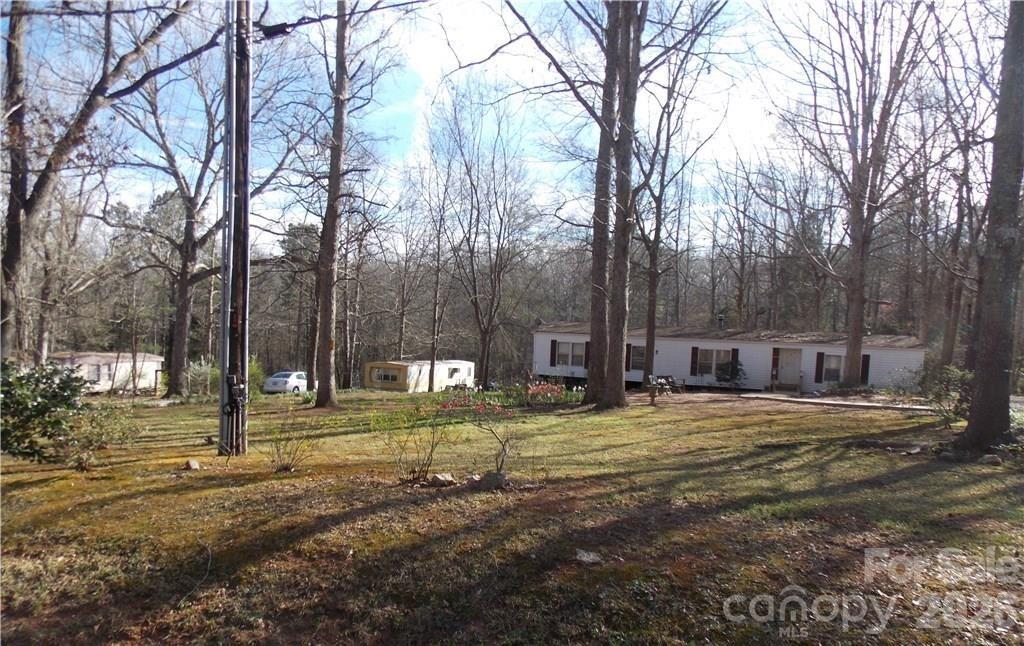 TENANTS IN PLACE...DO NOT DISTURB TENANTS..Appt required.   Wow what a low maintenance INCOME PRODUCING property that has 1 double wide and 5 single wides situated on 8 peaceful wooded acres convenient to I-77 and Hwy 21.  Have rental income figures on file.  All occupied but one single wide.  CALLING ALL INVESTORS!