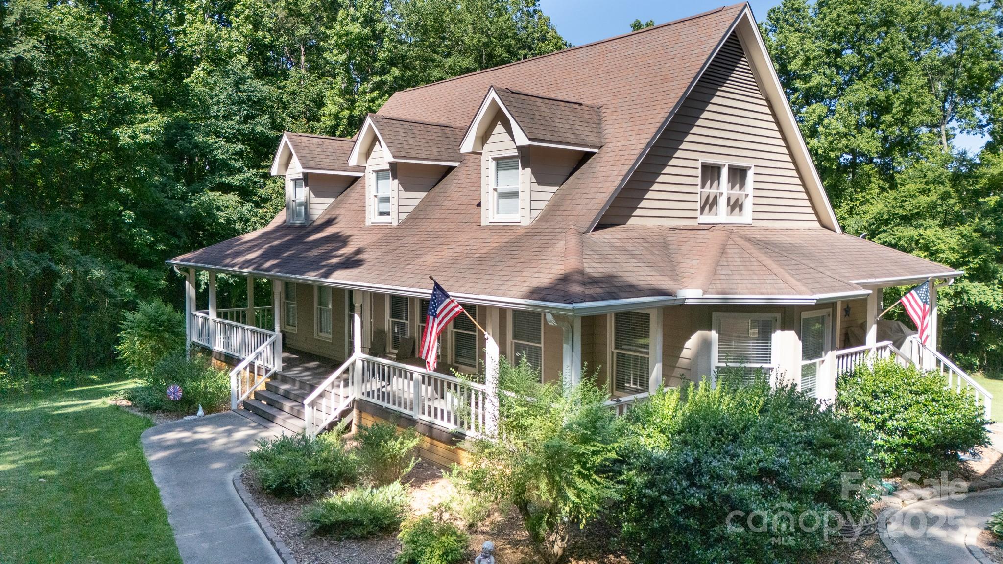 This home offers comfort, space and privacy.  Enjoy mornings on the covered front porch or entertaining on the large back deck.  The 4 Bedroom, 3.5 Bath home has been updated with new flooring and carpet (2020).  Complete primary bath and kitchen renovation (2021).  A separate bedroom and full bath above the garage offer the perfect space for guests, a home office or family retreat.  Other highlights include: new gutters and downspouts 2021, water softener filtration system 2021, crawl space professionally encapsulated 2023, full RV 50 amp hookup service and dump station 2020 and a Renai tankless water heater 2025.  This home combines modern convenience with natural tranquility.