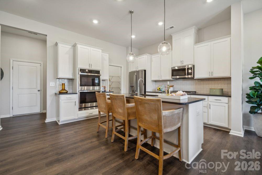 What's Special: Wooded View | Oversized Garage | White Cabinets | West Facing Lot | High Ceilings. New Construction - August Completion! Built by America's Most Trusted Home Builder. Welcome to the Aspen at 8687 Miles Gap Road in Ridge at Sugar Creek! This thoughtfully designed new two-story townhome offers an open and inviting main level where the great room flows into the casual dining area and a well-appointed kitchen, creating a comfortable space for everyday living. A convenient powder room adds functionality, while the two-car rear garage includes extra storage space for added organization. Upstairs, the loft features a dedicated tech space ideal for working or studying from home. The primary suite provides a relaxing retreat with a spacious bath and walk-in closet, complemented by two secondary bedrooms, a full bath, and a centrally located laundry room. Pool and cabana now open! Ridge at Sugar Creek in Indian Land, SC, offers a welcoming lifestyle with a new pool and planned greenway trail. Just 4.5 miles from Ballantyne, you’ll enjoy easy access to I-77, I-485, and the Ballantyne Bowl’s dining and events. Commuting is simple with quick routes to Uptown Charlotte and Ballantyne Corporate Park. Additional Highlights Include: laminate flooring extension on 1st floor, 30" gas range, upgraded microwave vent hood, sing bowl undermount kitchen sink, and 220 volt/50 amp outlet at garage. Photos are for representative purposes only. MLS#4381479