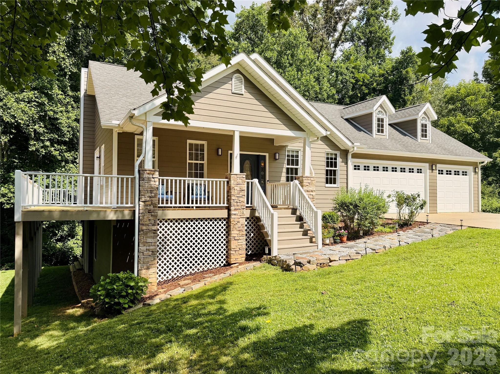 Enjoy the convenience of primarily main-level living in this thoughtfully designed, one-owner, well-maintained 3BR/2.5BA home nestled in a beautiful park-like setting within the desirable Reems Creek Golf Community. The main level features a spacious primary suite with a large walk-in closet and sitting area, a dedicated office, laundry room, hardwood floors, tall ceilings, and open living spaces designed for everyday living and entertaining, creating a comfortable, functional layout. The living room features a fireplace, abundant windows, and oversized French doors that bring the outdoors in and open to the expansive wraparound deck, partially covered for year-round enjoyment. The attached heated 3-car garage adds everyday convenience, offers enhanced electrical capabilities that car enthusiasts will appreciate, and provides ample space for vehicles and a golf cart. The lower level offers two additional bedrooms (one with a large walk-in closet), a full bath, a welcoming family room with a stone fireplace, and a versatile flex room ideal for exercise, play, studio, or home office. Tall ceilings and recessed lighting continue on the lower level, enhancing the home's spacious feel. Abundant storage, including a lower-level utility garage and large storage room, adds to the home's functionality. The utility garage also provides an alternative space for a golf cart, if desired. Outdoor living is a highlight, with a mature landscape creating a peaceful setting for relaxing and entertaining. Ideally located just minutes from downtown Weaverville, Asheville, shopping, dining, and recreation, this home offers comfort, flexibility, and room to spread out. The community is home to Reems Creek Golf Club, a semi-private club offering golf and social memberships, along with a clubhouse, restaurant, pool, and pickleball courts.
